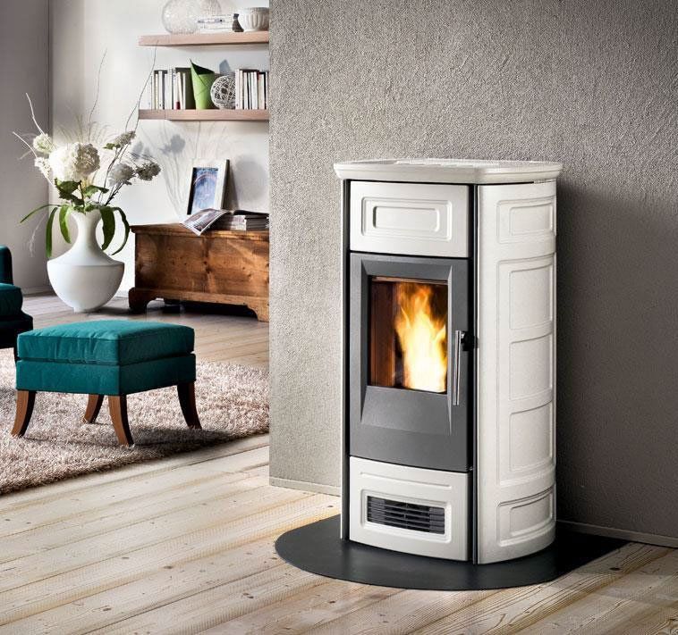 A sleek white pellet stove standing against a wall.