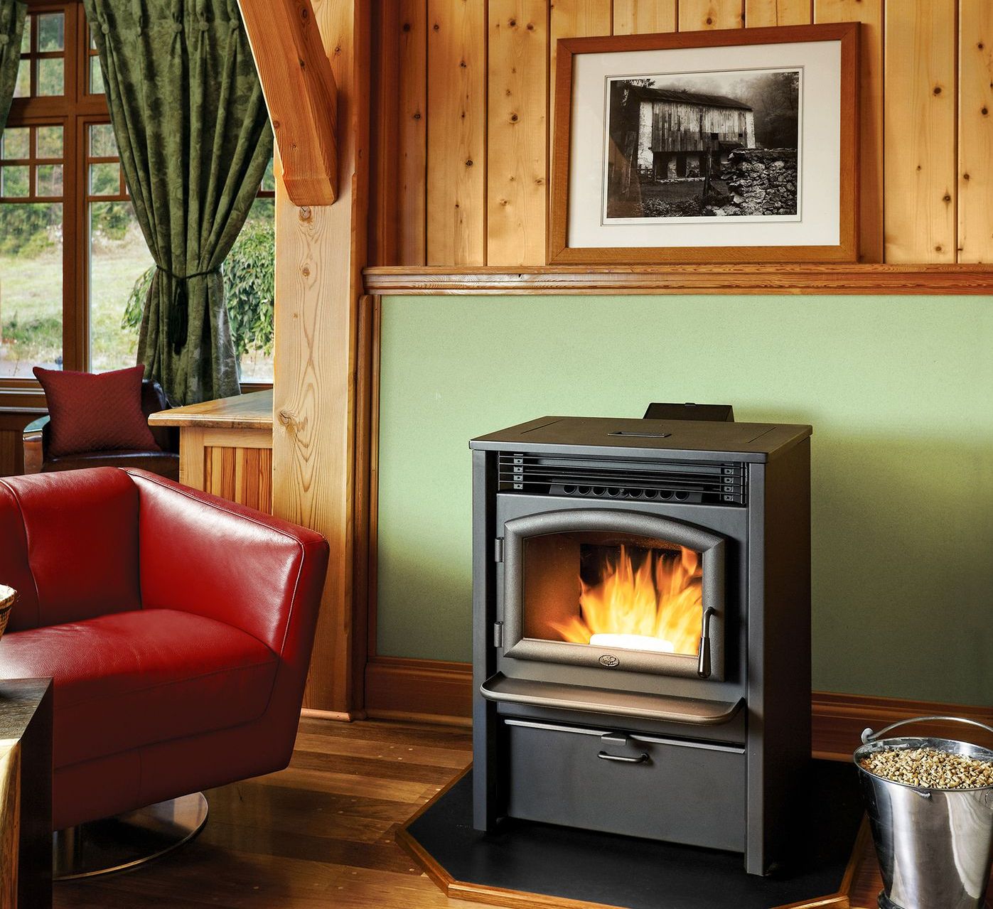 An efficient pellet stove emitting a warm, cozy flame within a sleek black frame, surrounded by a stack of wood pellets nearby.