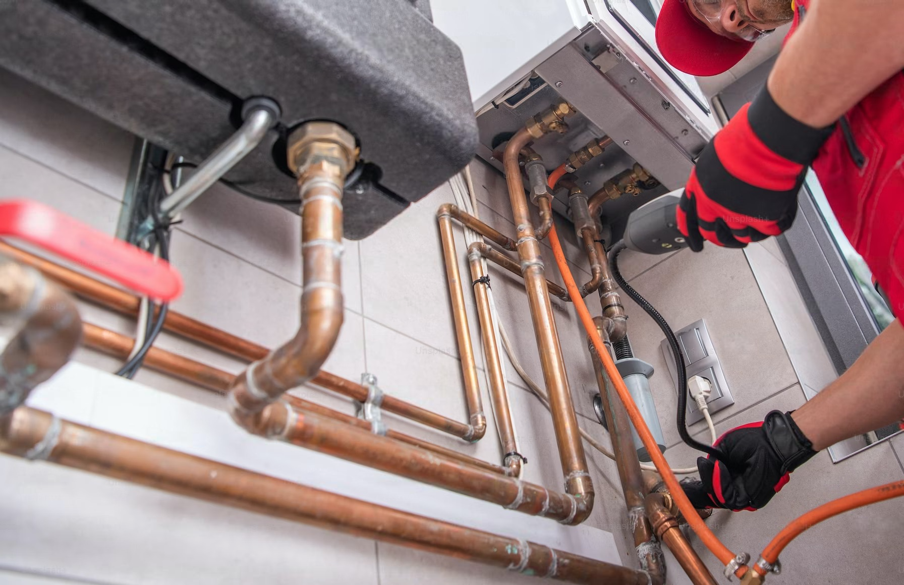 An experienced technician diligently repairing a heat pump unit, wearing protective gloves and using specialized tools to diagnose and fix the equipment.