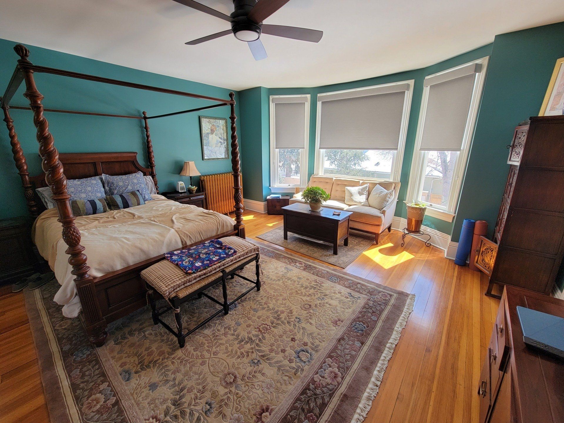 There is a four poster bed in the middle of the room.