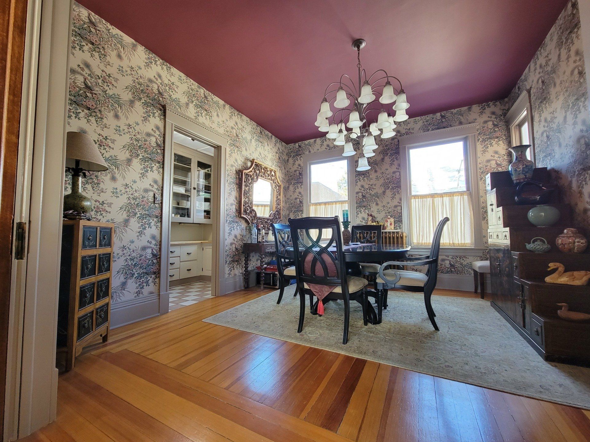 A dining room with a table and chairs and a chandelier.
