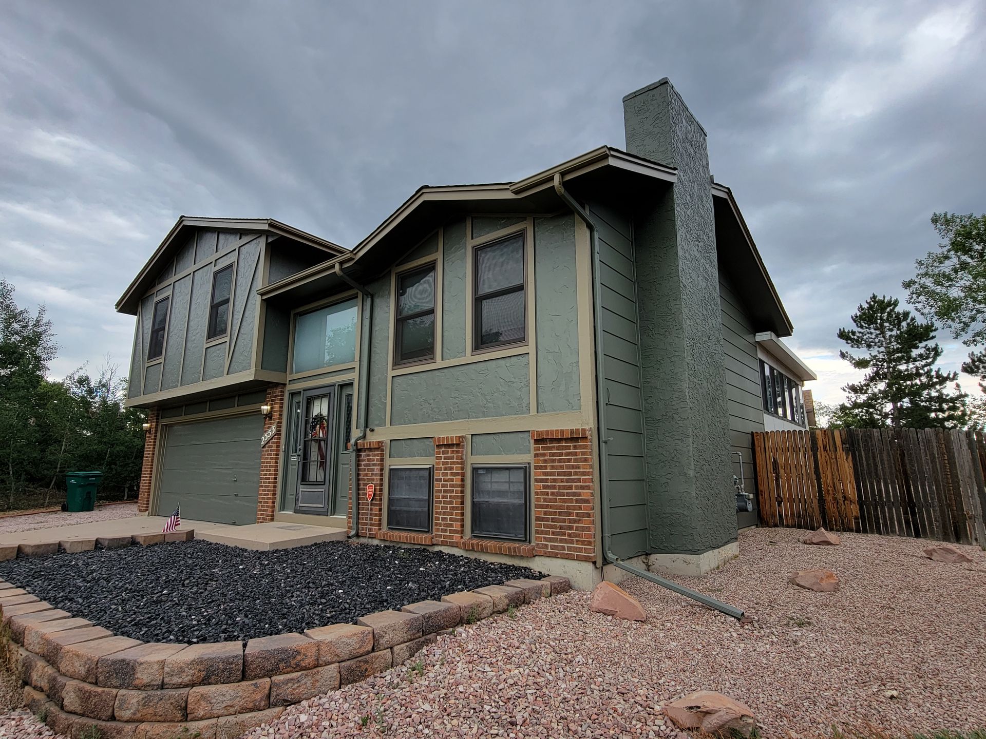 A large house with a lot of windows and a fire pit in front of it