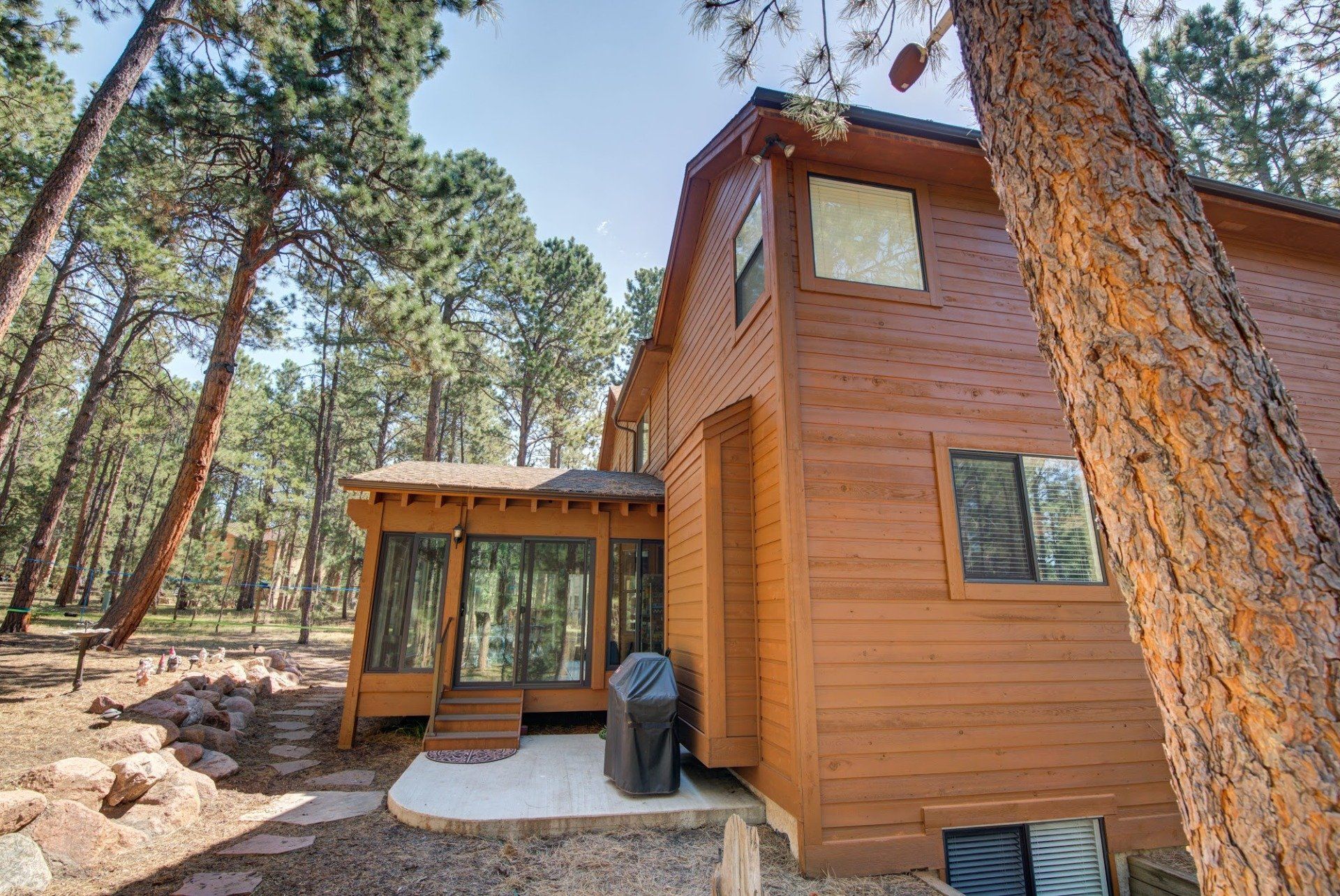 A large wooden house in the middle of a forest