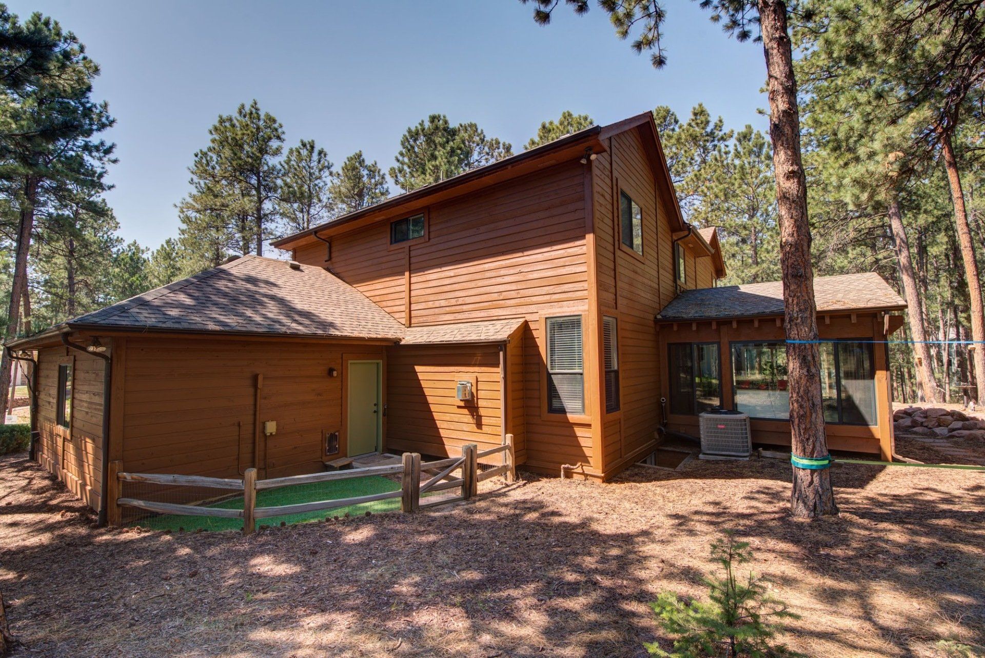 A large wooden house in the middle of a forest