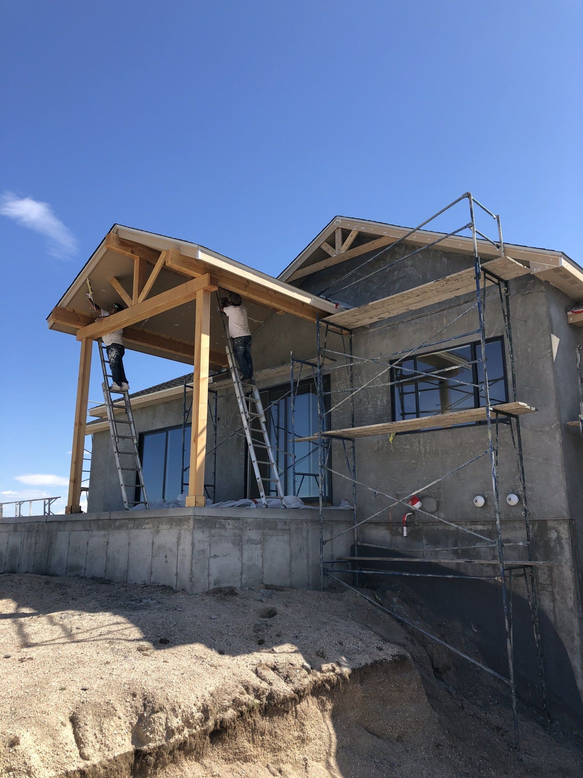 A house is being built on top of a dirt hill.