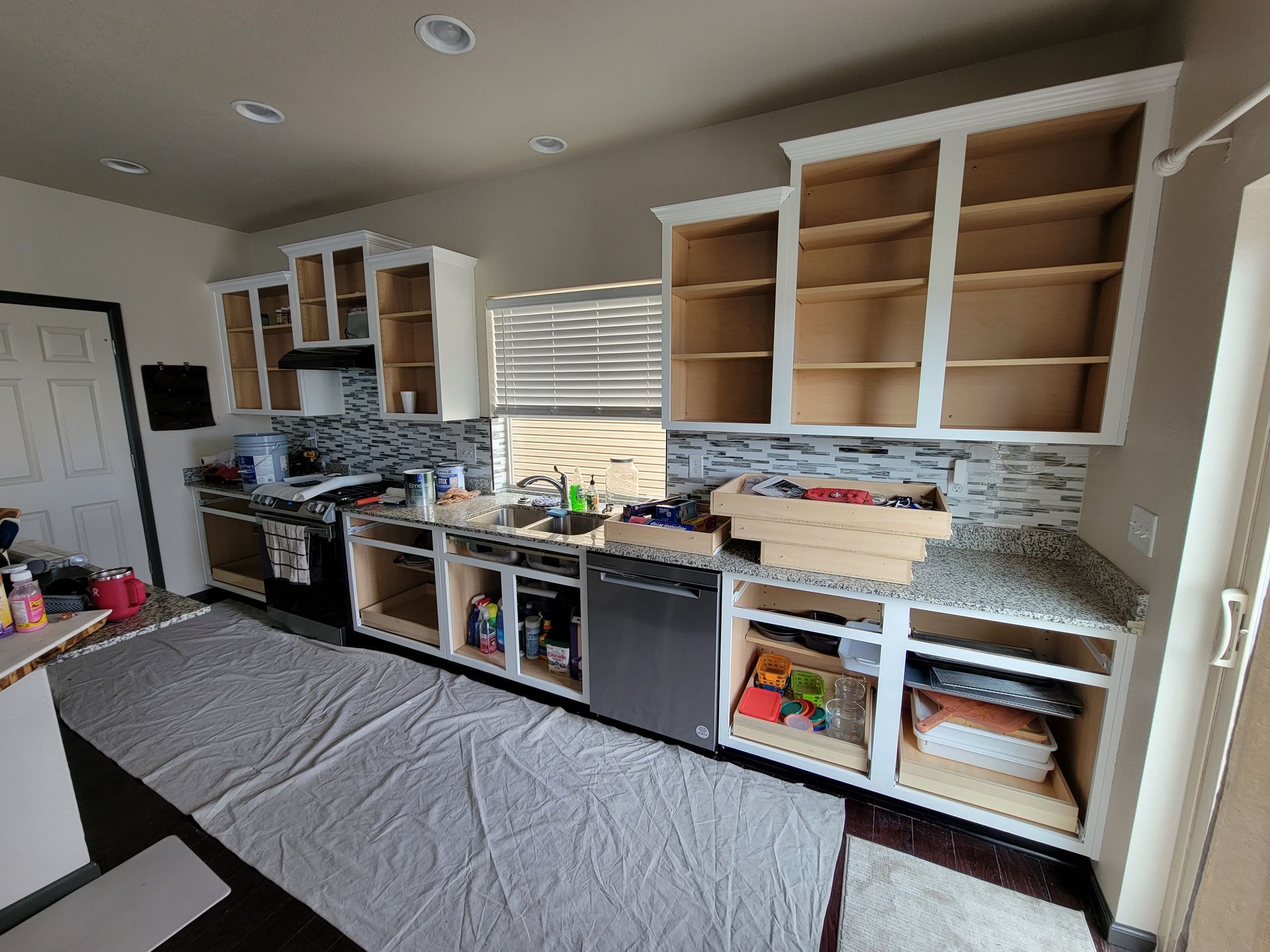 A kitchen with a lot of cabinets and a dishwasher.