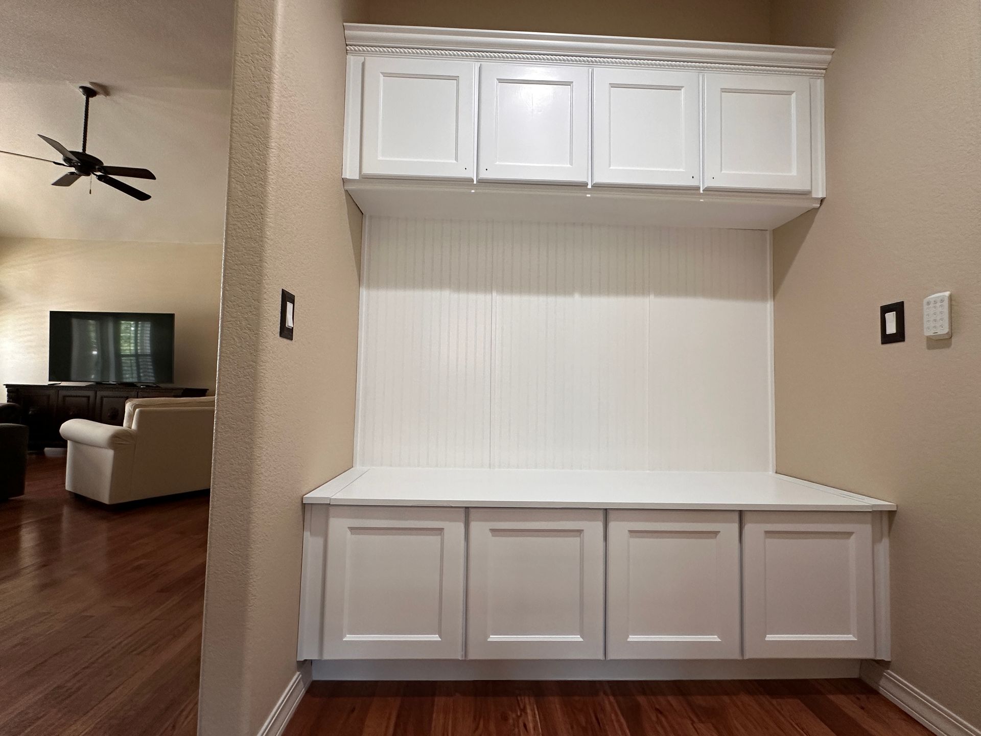 Cabinet Refinishing: A hallway with white cabinets and a ceiling fan