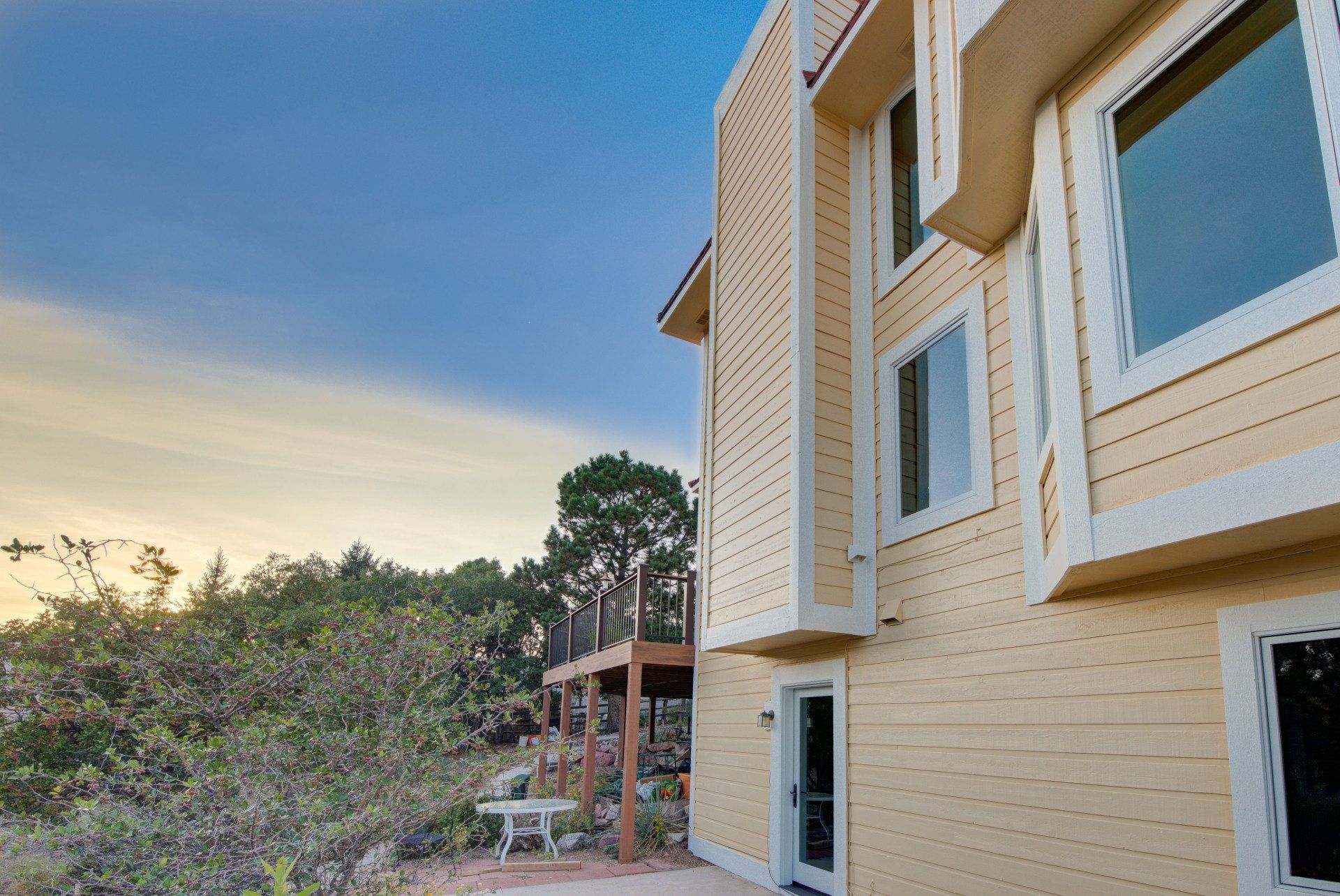 a large yellow house with a lot of windows