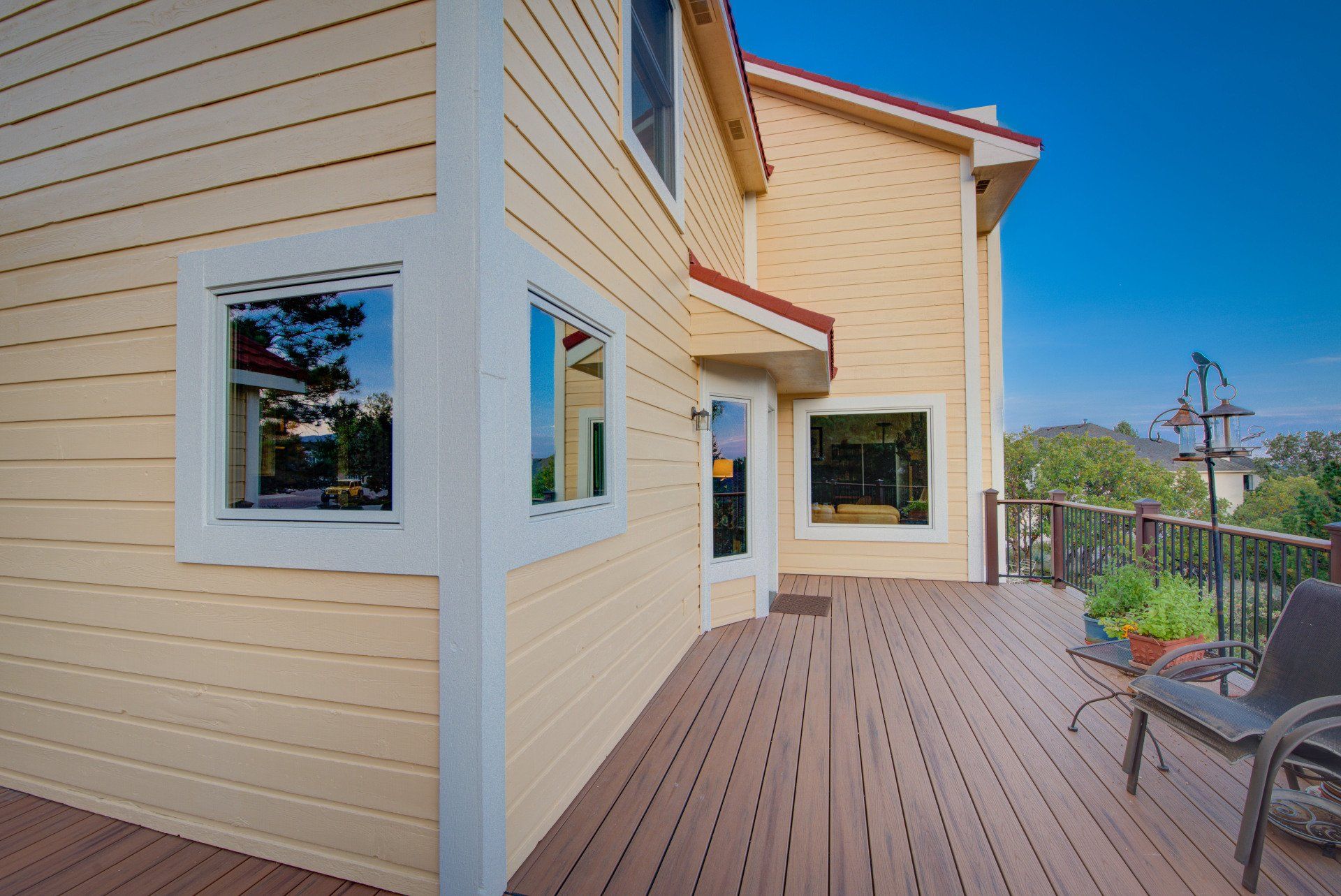 a large house with a large deck and a lot of windows