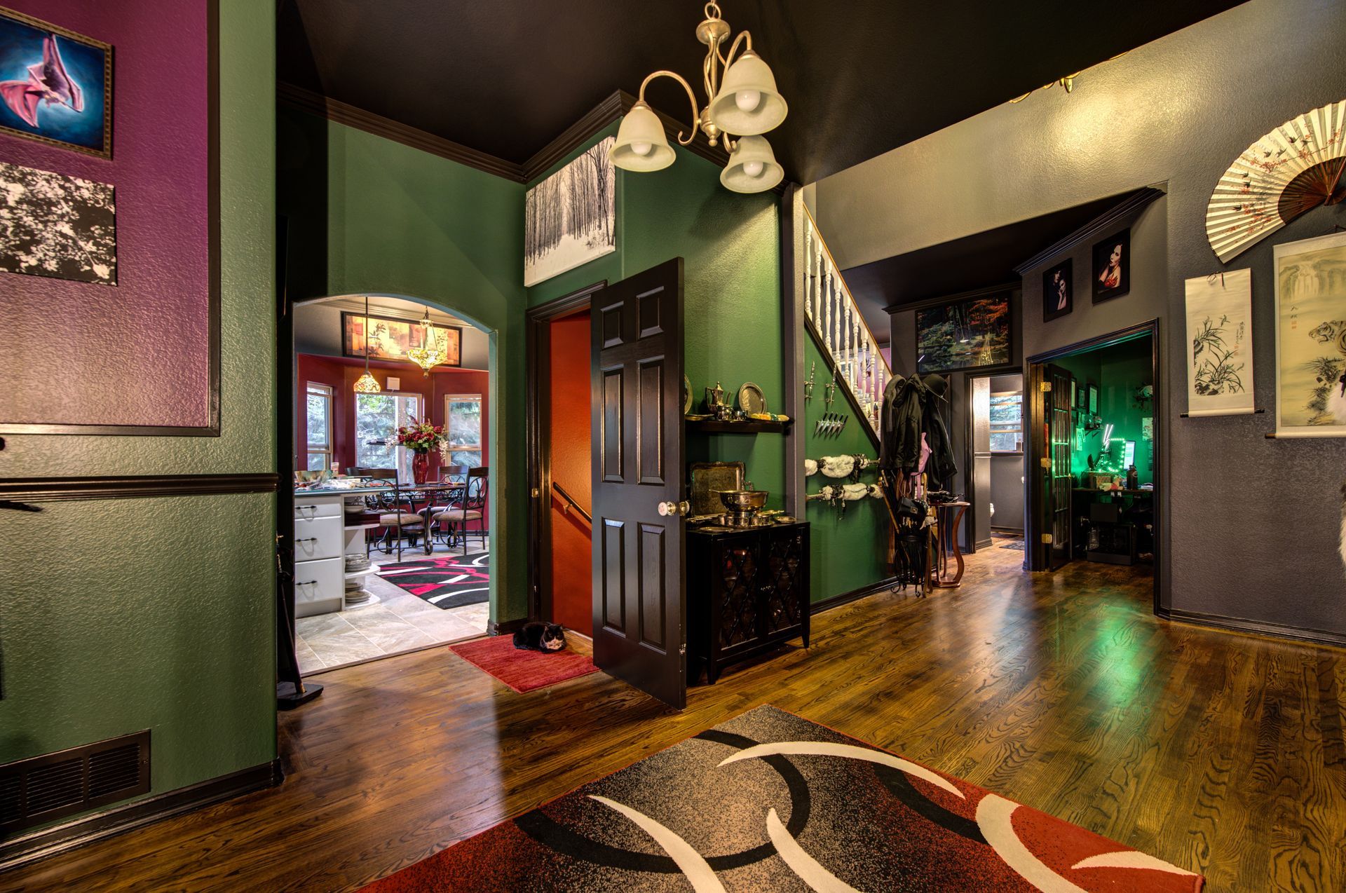 A large room with a rug on the floor and a staircase.