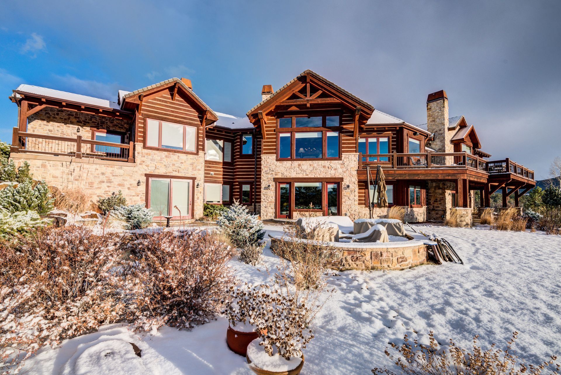 A large house is sitting on top of a snow covered hill in Colorado.