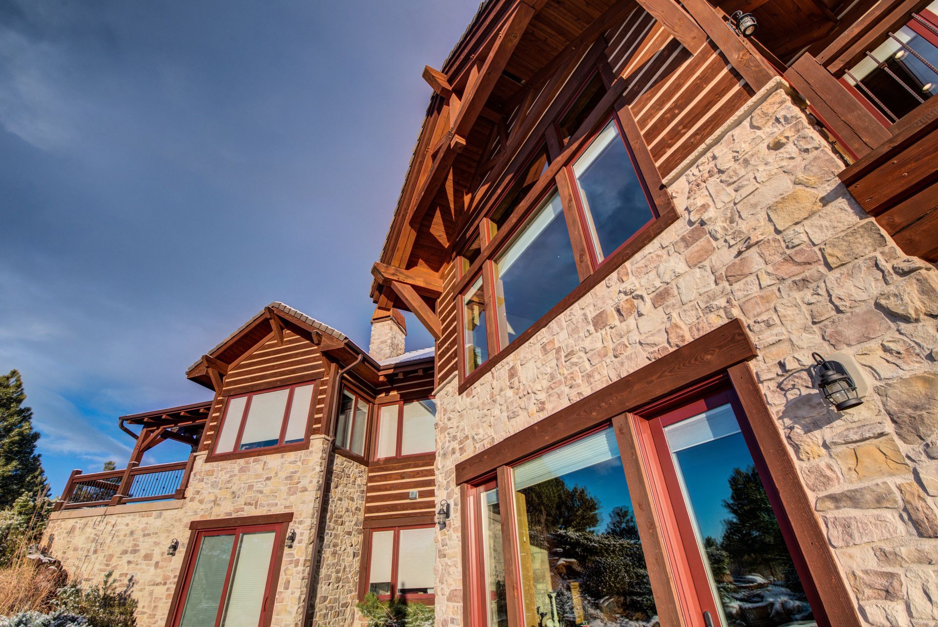 A large house with a lot of windows and a wooden roof.