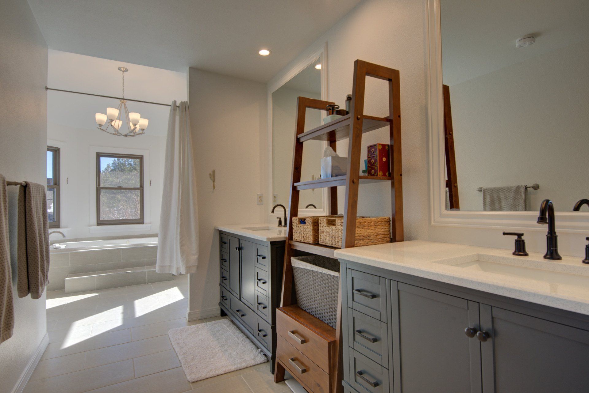 A bathroom with two sinks , a mirror and a bathtub.