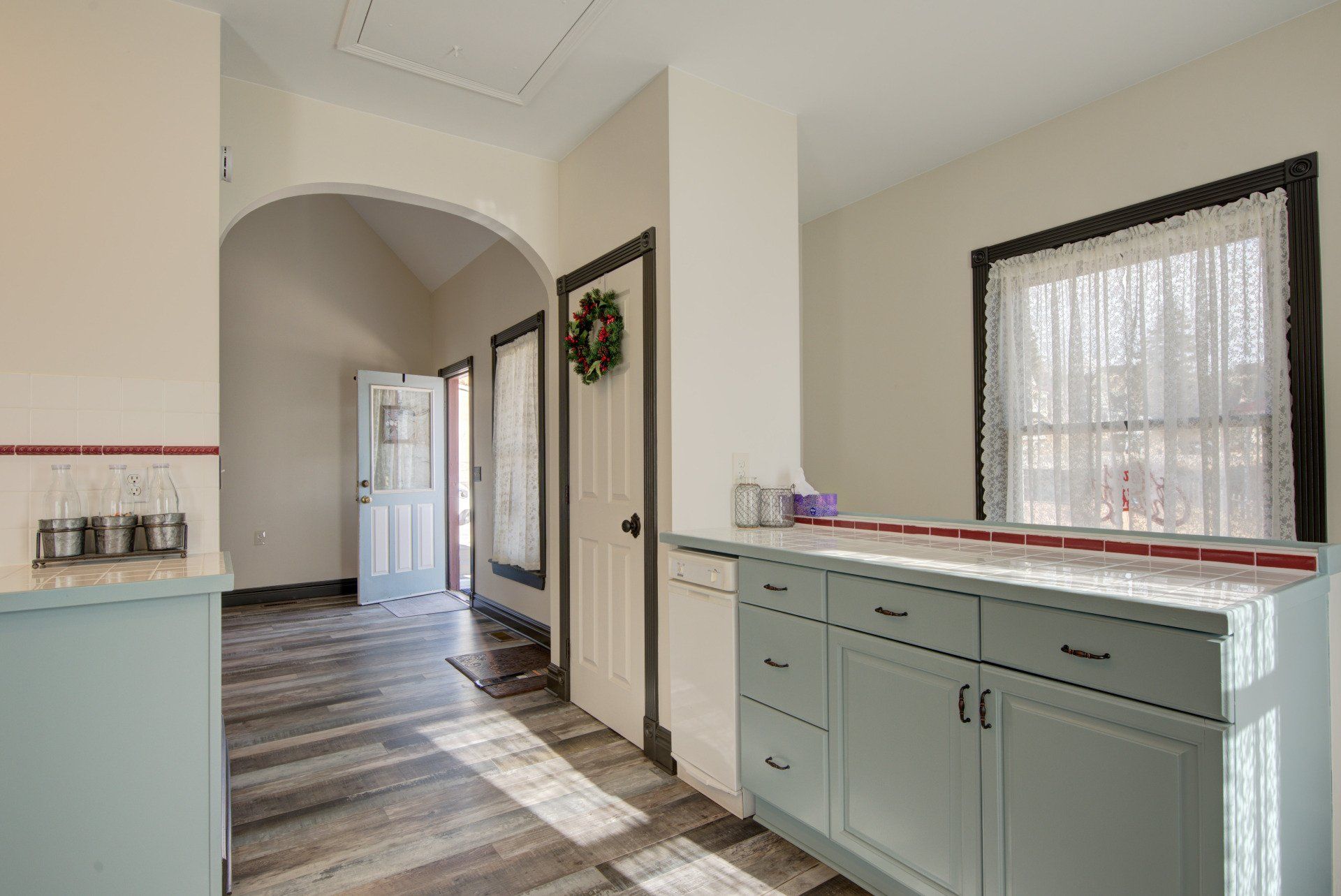 A hallway in a house with a wreath on the door.