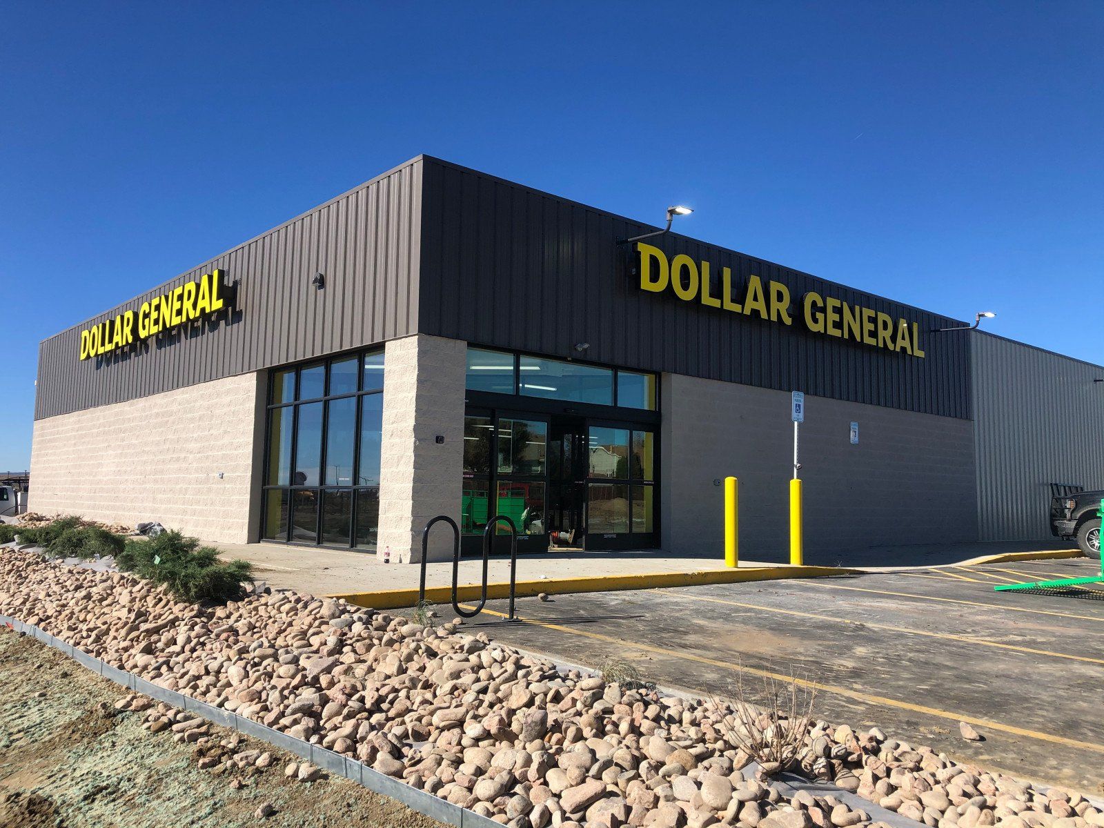 A dollar general store with a lot of rocks in front of it.