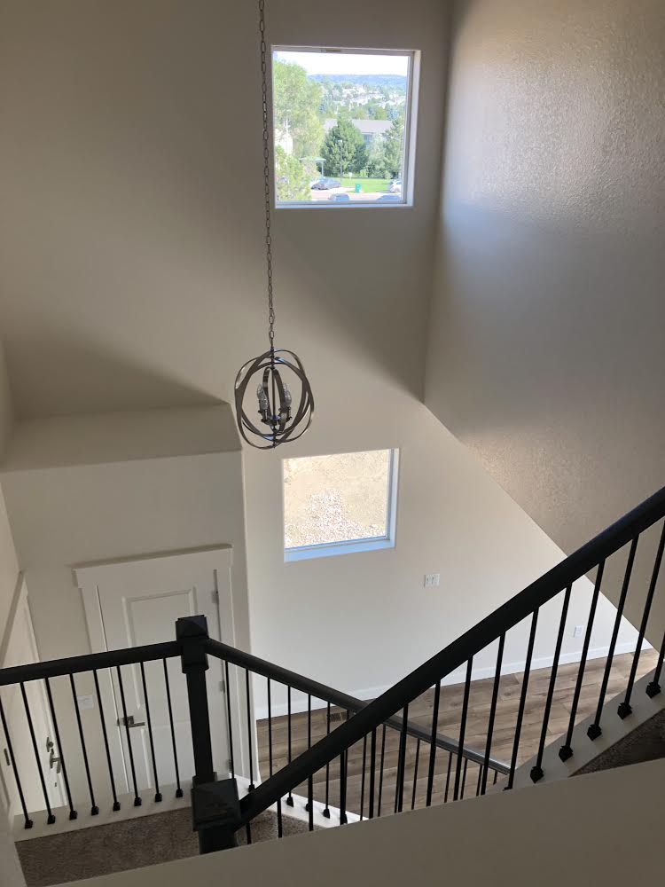 A view of a staircase from the second floor of a house.