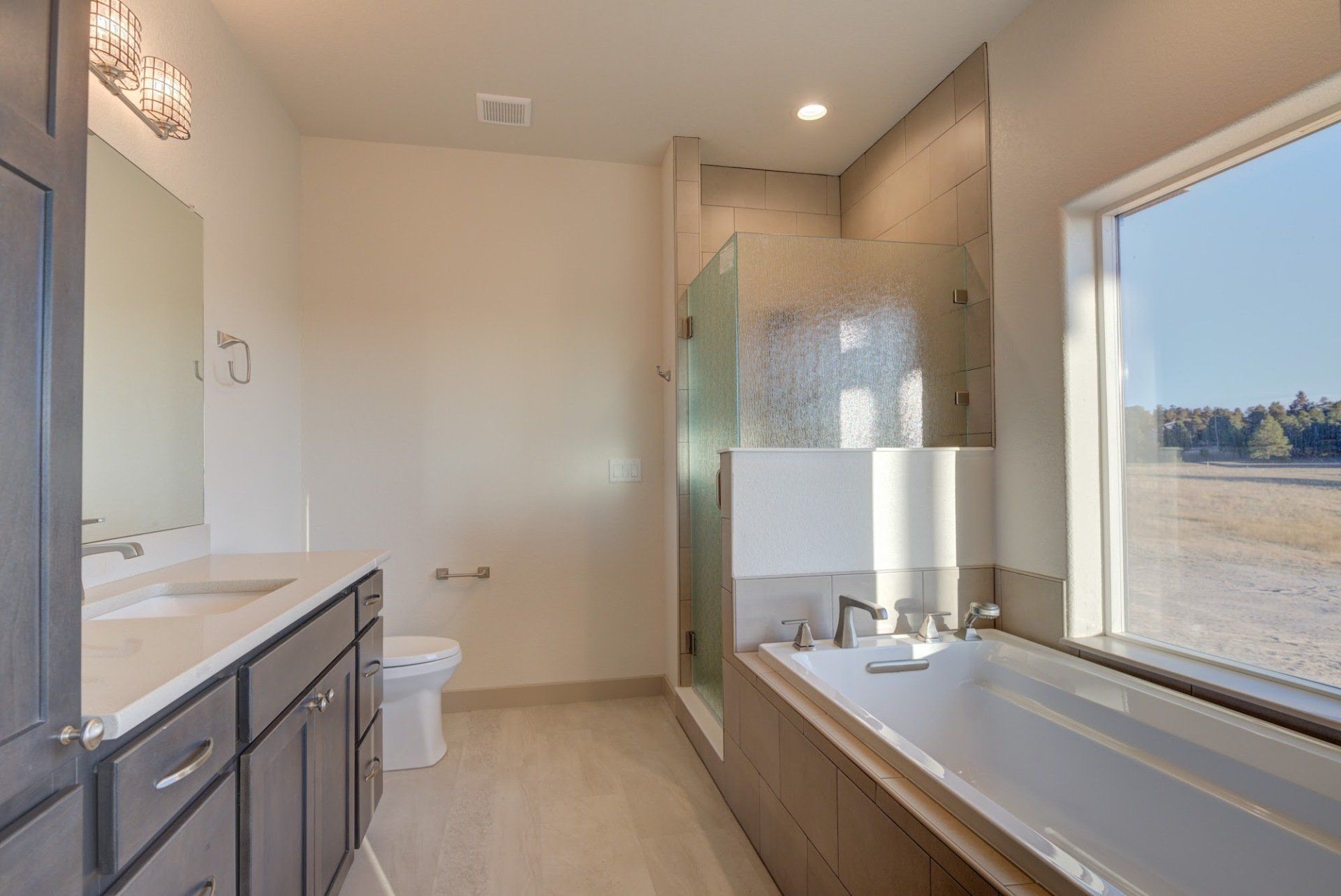 A bathroom with a tub , sink , toilet and shower.