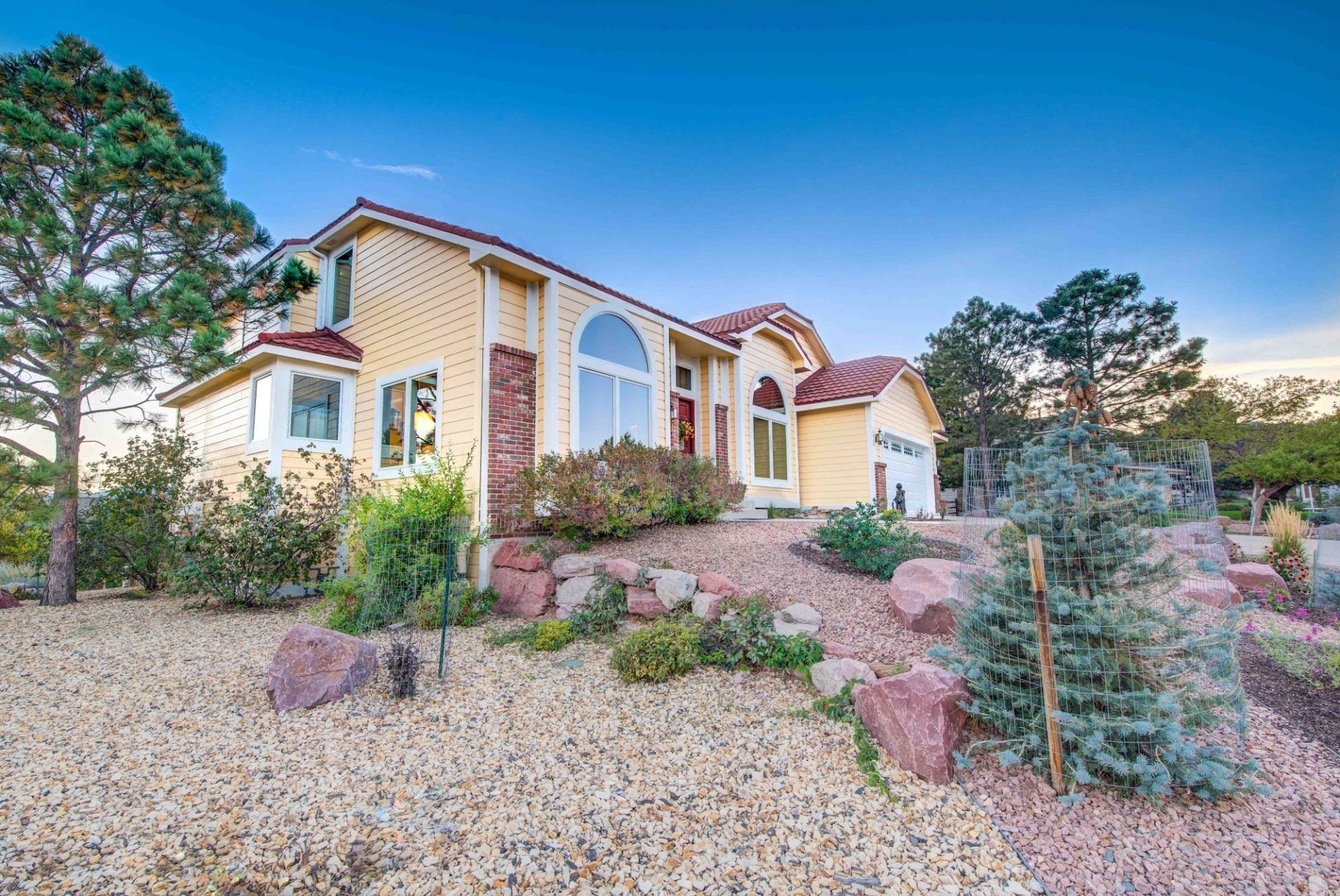 A large house with a lot of rocks in front of it.