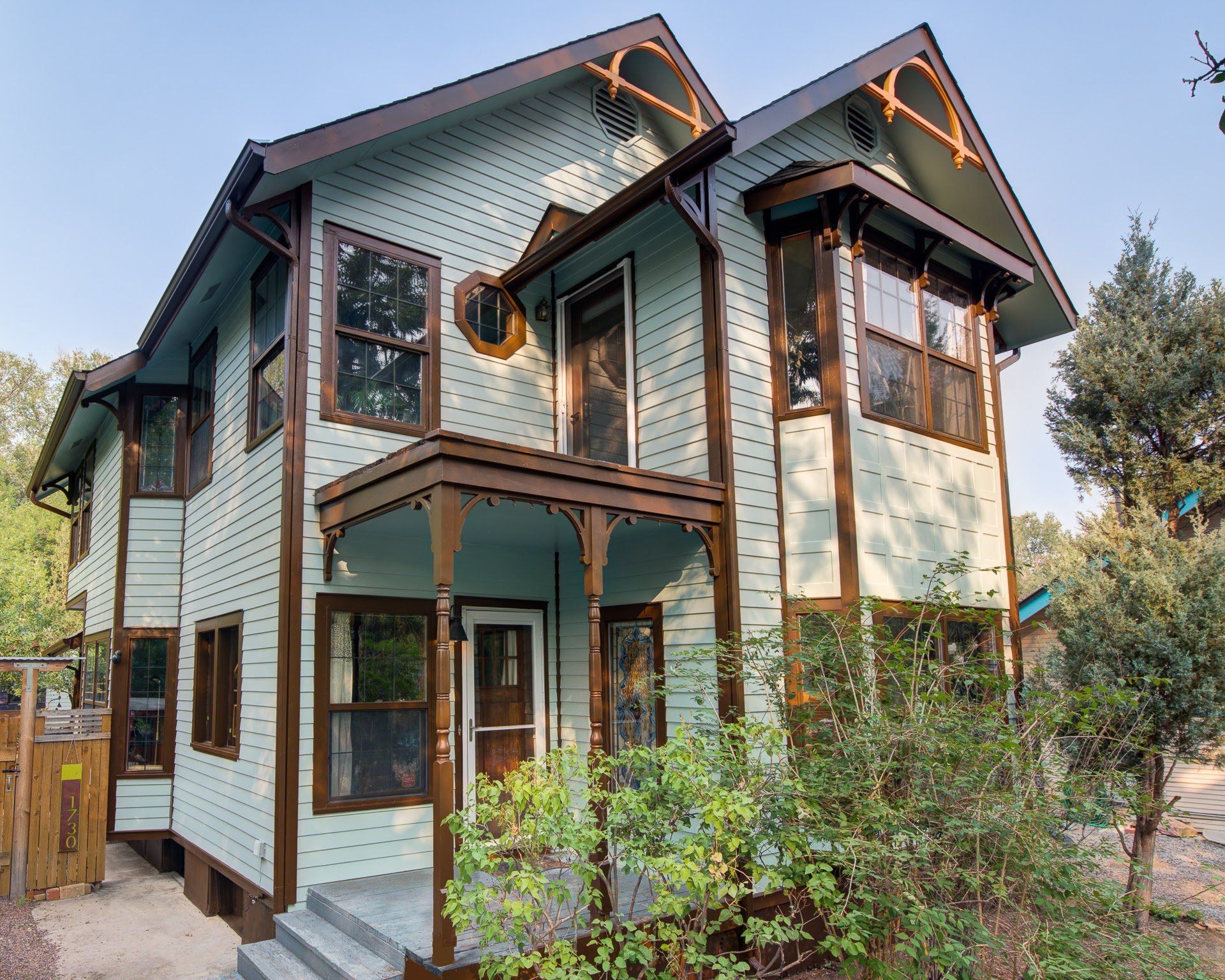 A house with a lot of windows and a porch