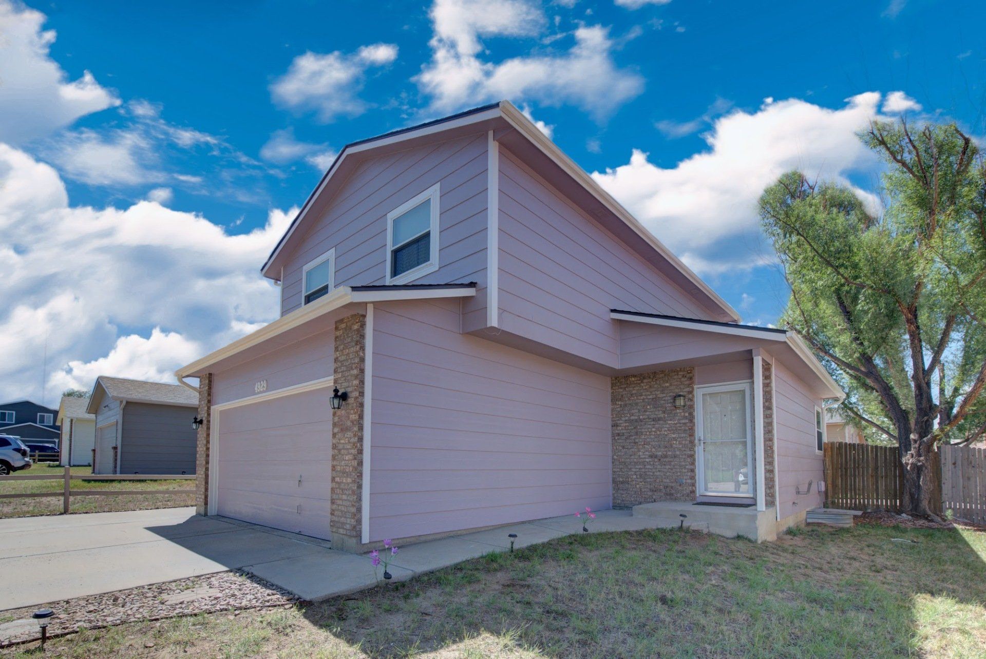 A pink house with a blue sky in the background
