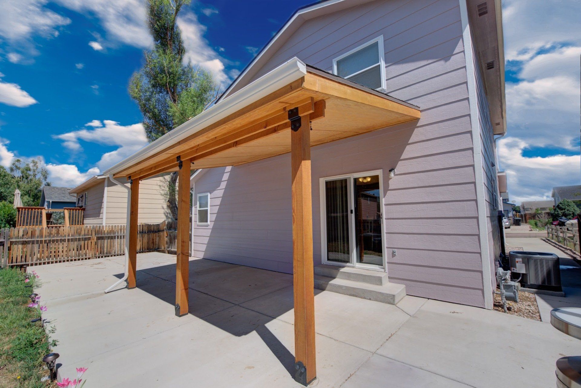 A house with a covered patio in front of it