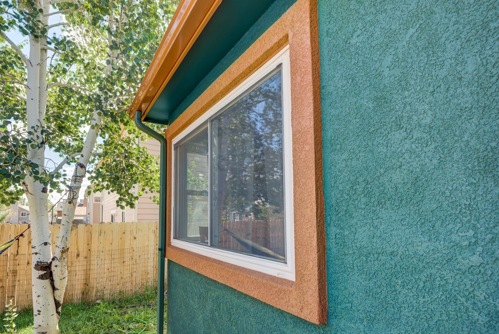 A house with a large window on the side of it.