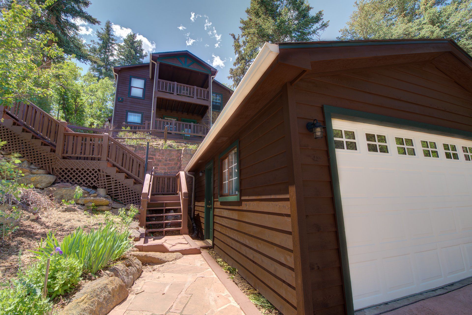 A house with a garage and stairs leading up to it