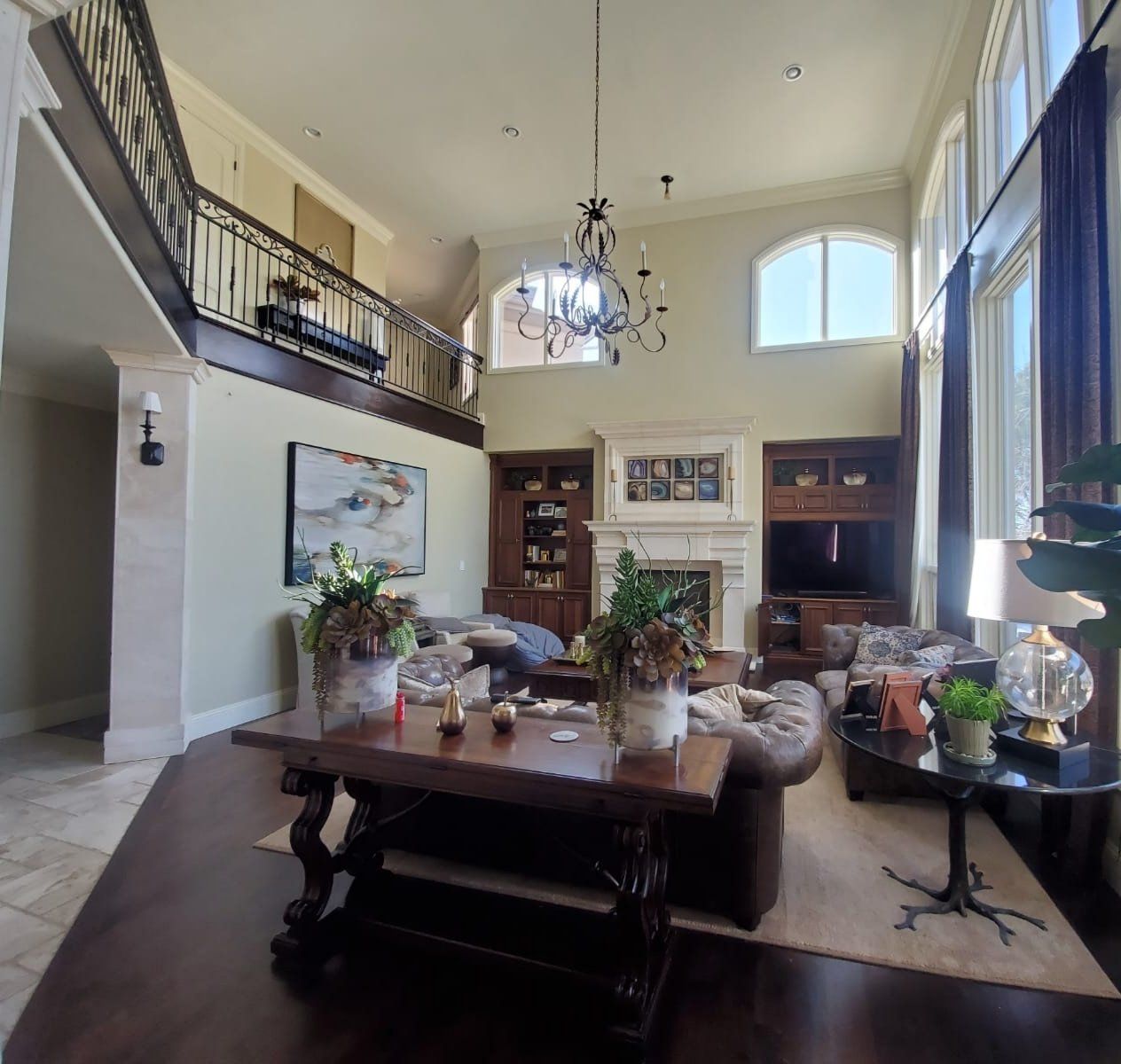 A living room with a couch a table and a fireplace