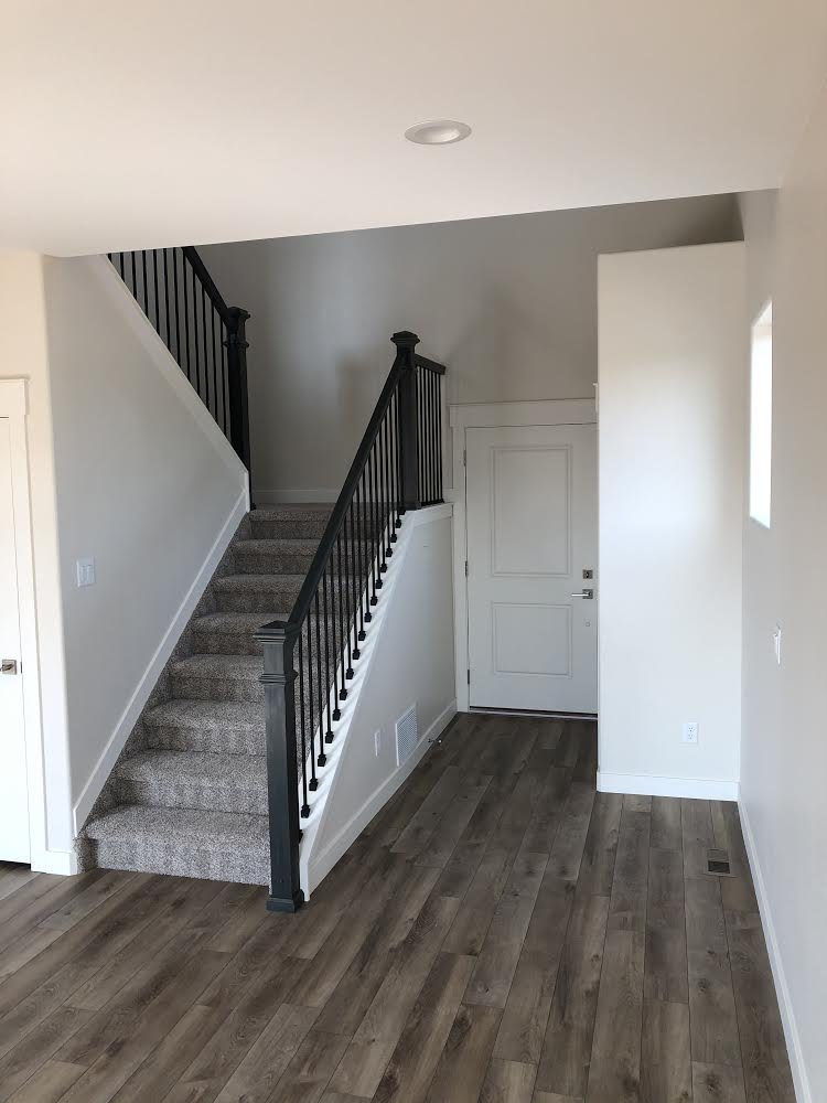 An empty hallway with stairs leading up to the second floor