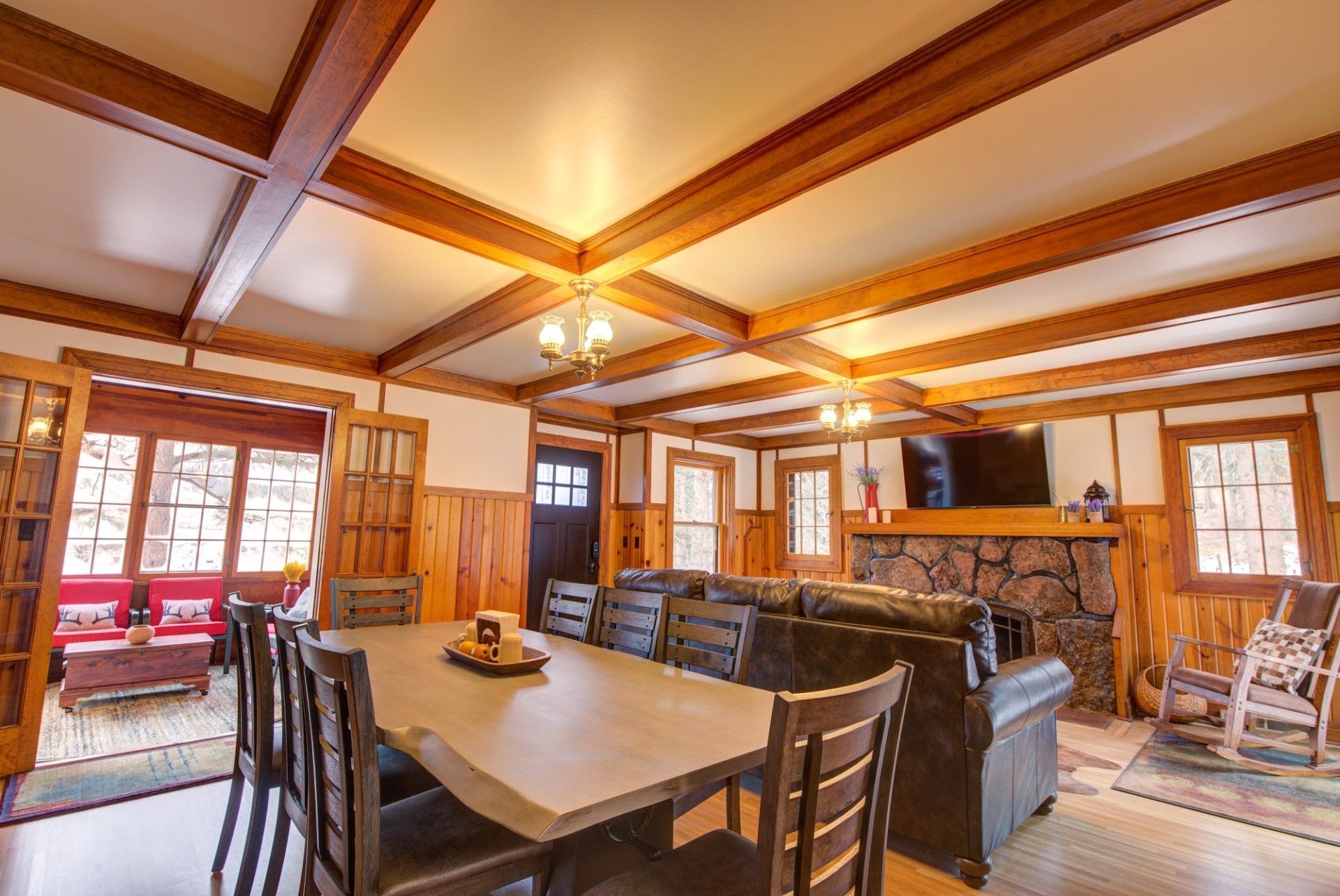A living room with a table and chairs and a fireplace.