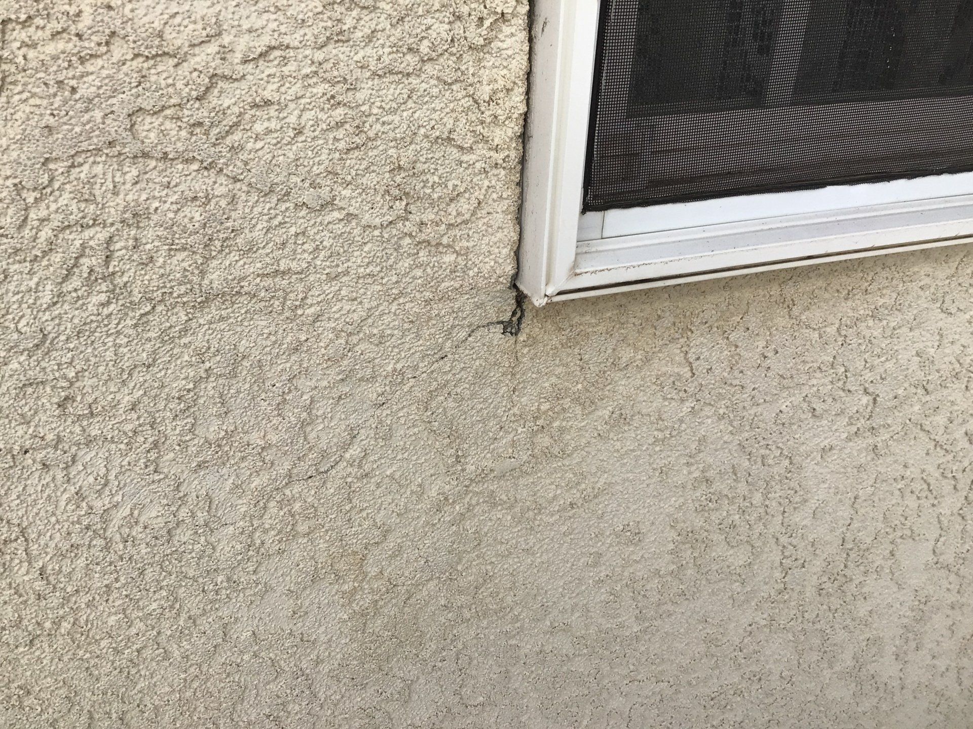 A close up of a window on a wall with a screen on it.