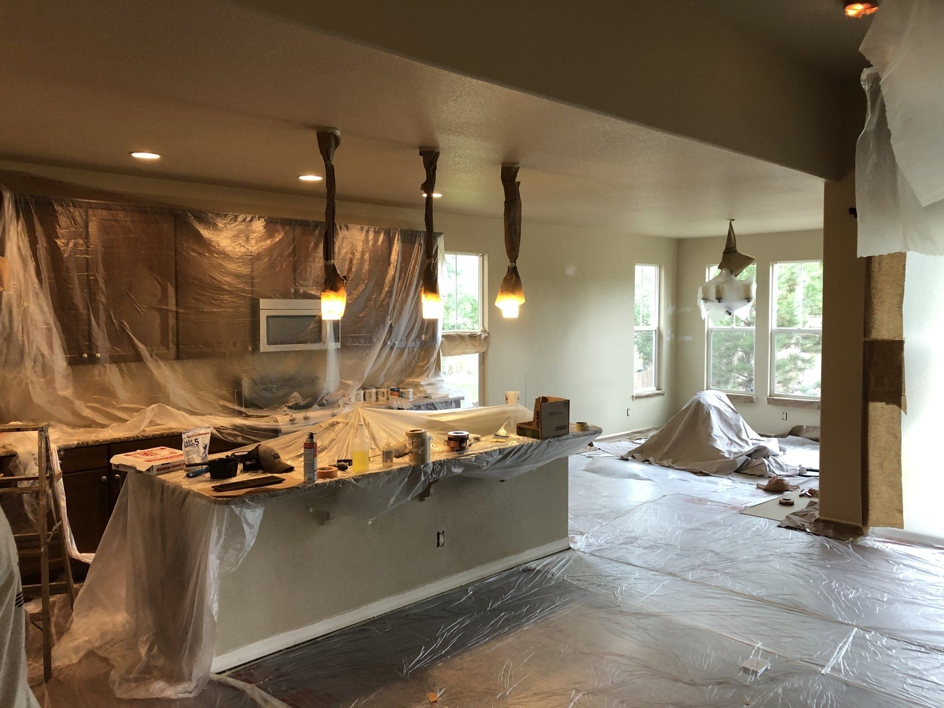 A kitchen is being painted in a house.