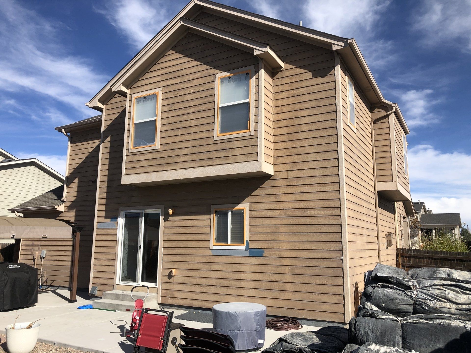 A large house with a lot of windows and a sliding glass door