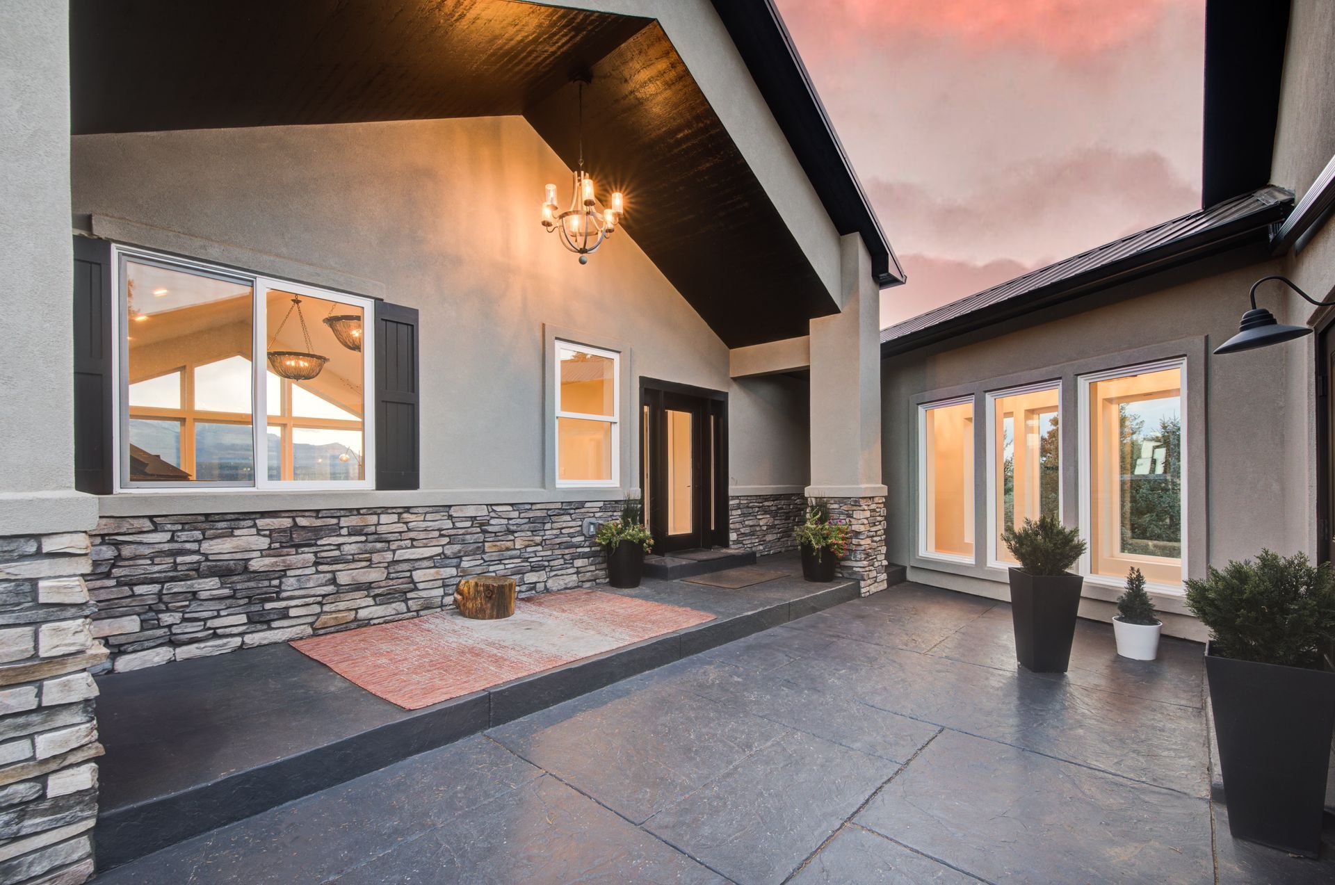 Painting a large stucco house with a lot of windows and a large porch in Castle Rock