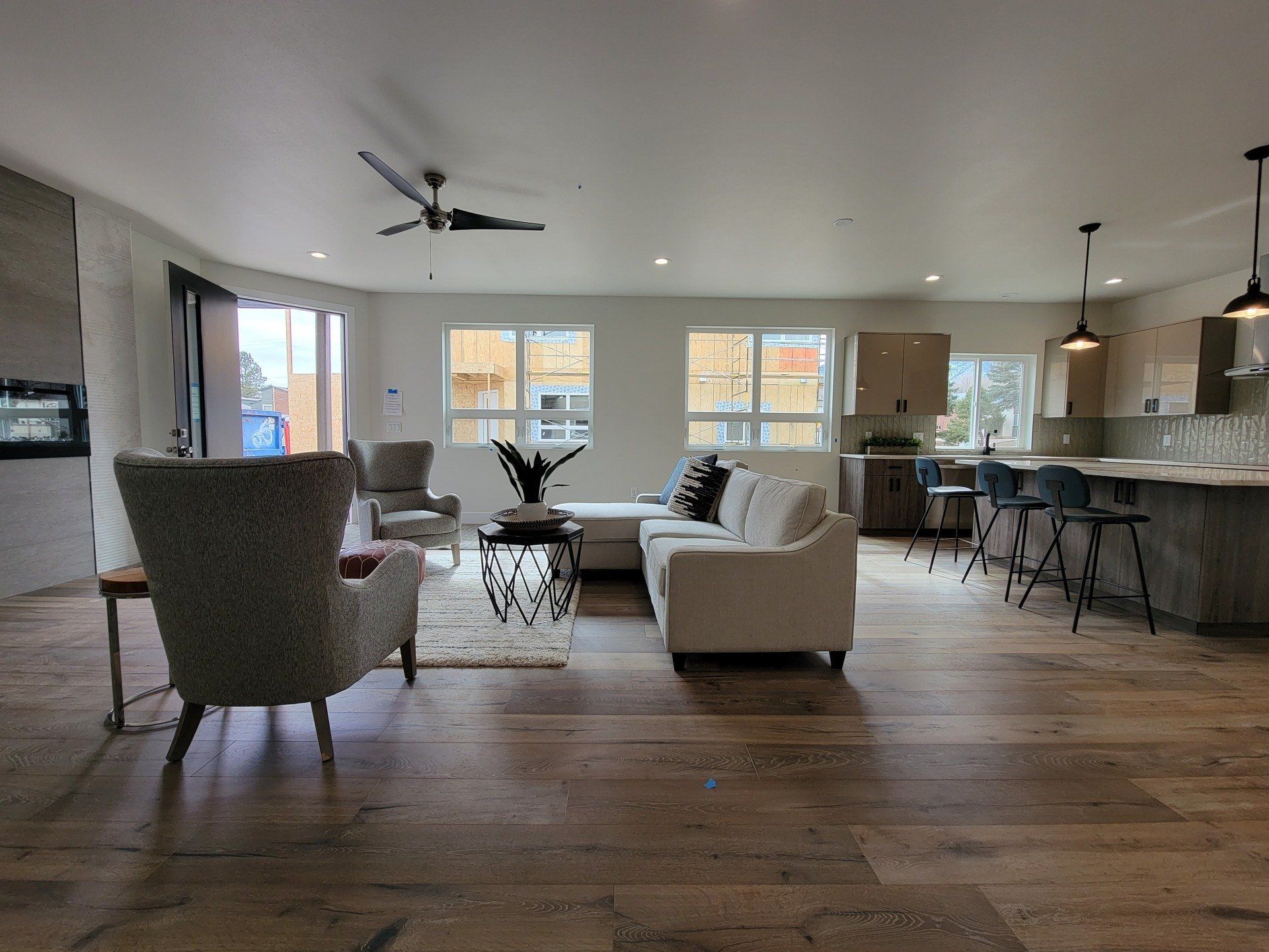 A living room filled with furniture and a ceiling fan.