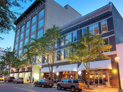 A building with a lot of windows and cars parked in front of it
