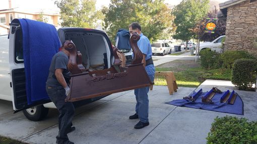 two men moving pool table