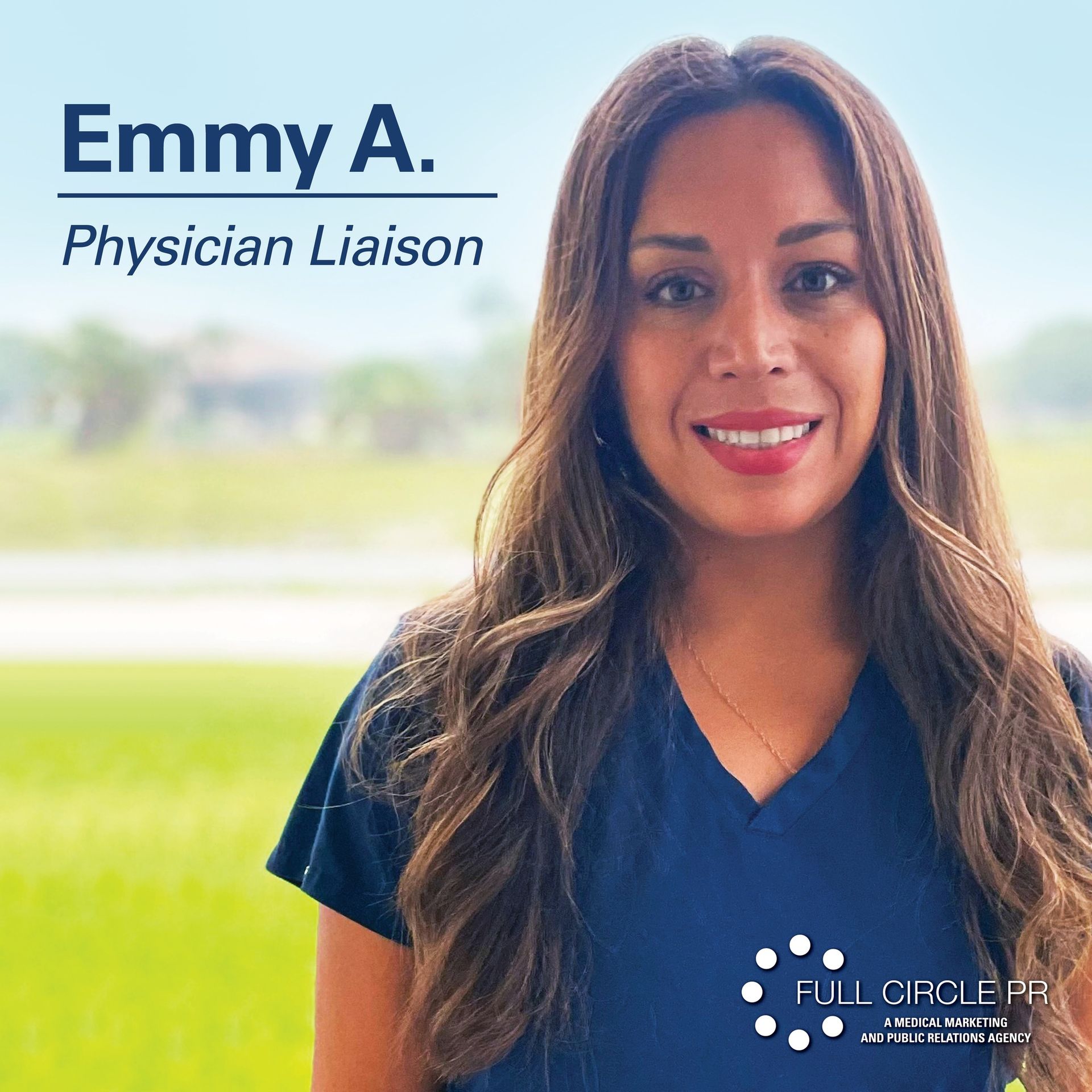 Emmy A., Physician Liaison, smiling in front of a blurred outdoor background. She wears a dark blue top.