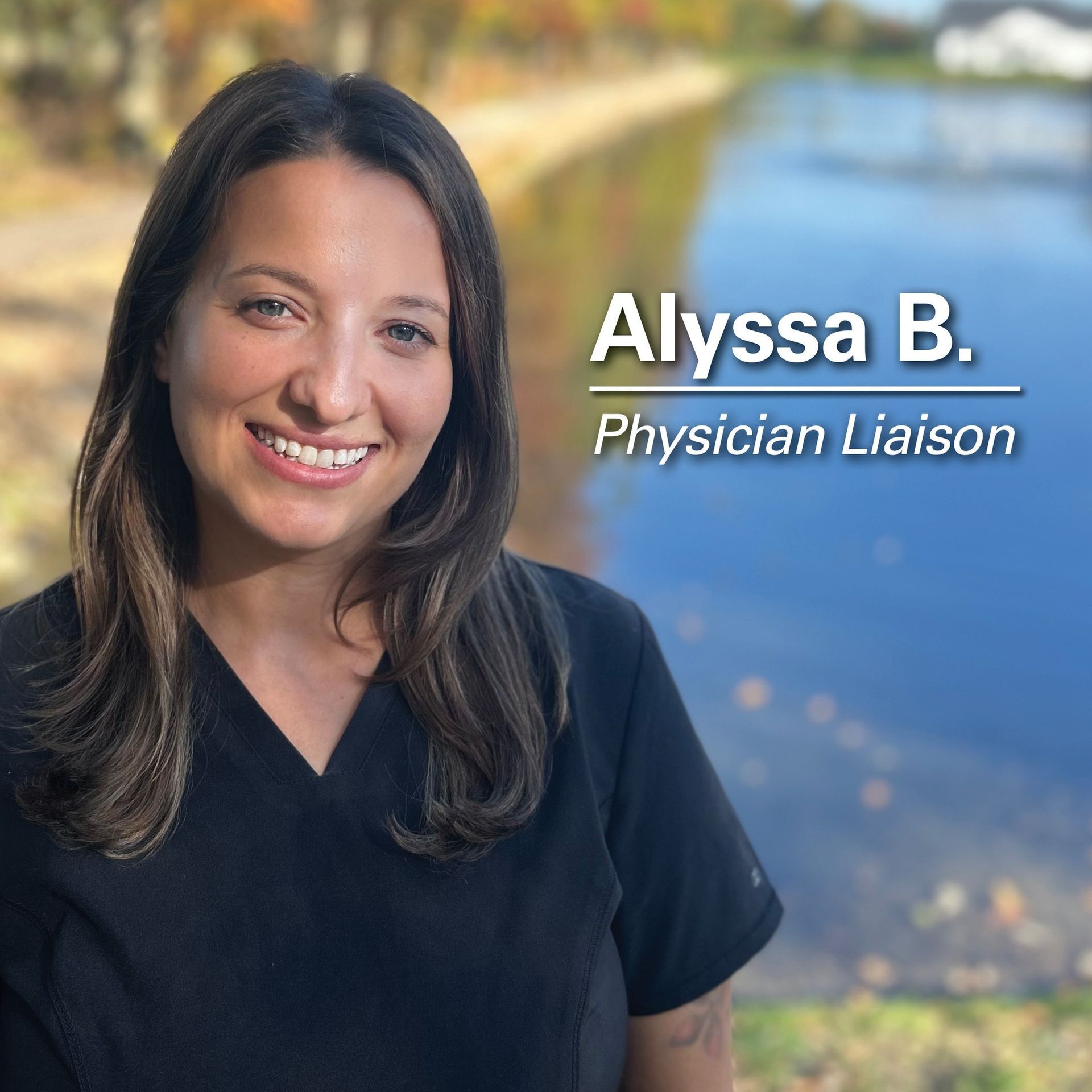 Alyssa B., Physician Liaison, smiling in front of a blurred outdoor scene. Wearing a black top.