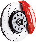 A close up of a brake disc with a red brake caliper. | Sunset Tire and Auto Repair