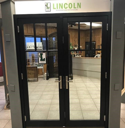 a black double door with a sign that says lincoln on it