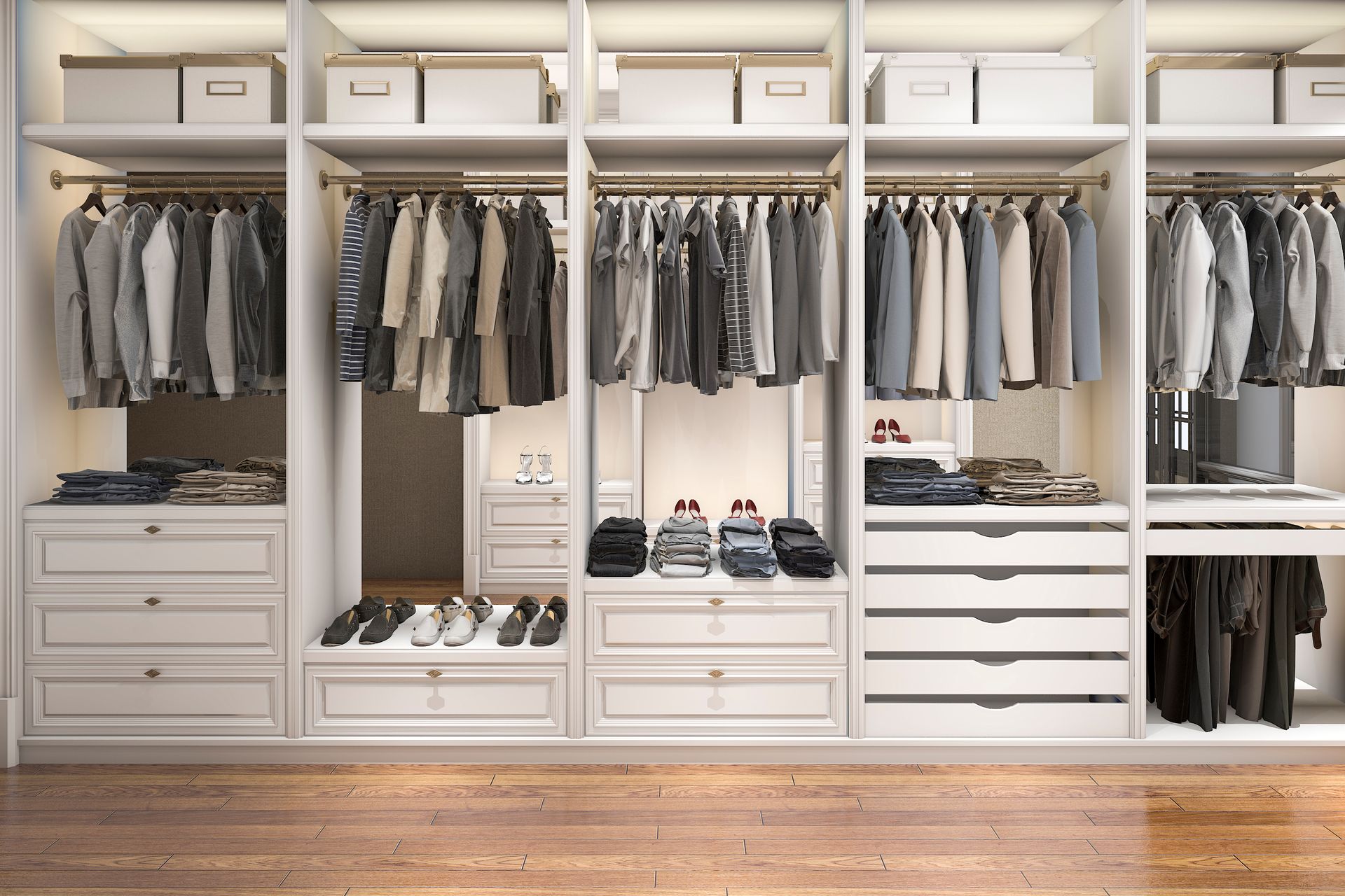 Built-in white closet with hanging clothes, drawers, and storage bins. Light wood floor.