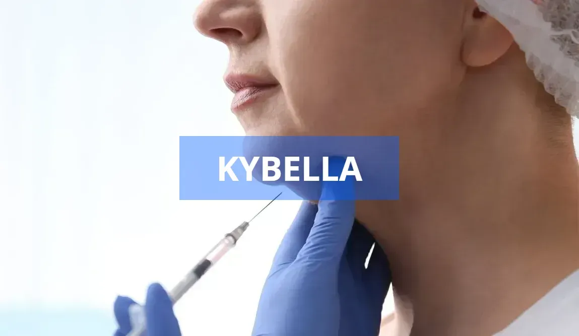 A person's chin being injected with Kybella. A medical professional in blue gloves holds the chin and administers the injection.