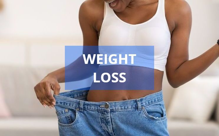 A Black woman smiles while holding up loose jeans, showing weight loss; blue text reads 