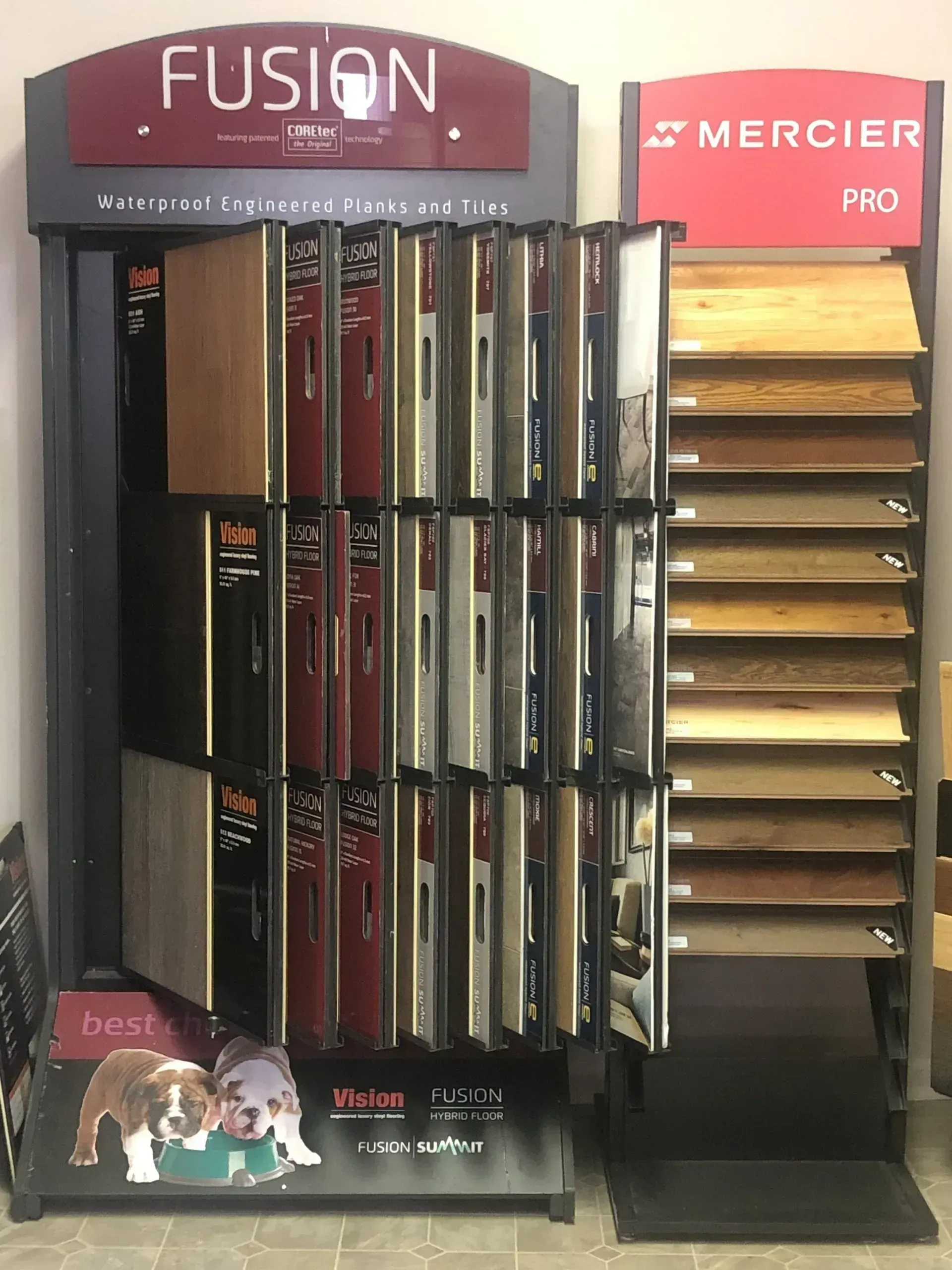 Display stands showcasing various hardwood flooring samples, including Mercier and Fusion brands.
