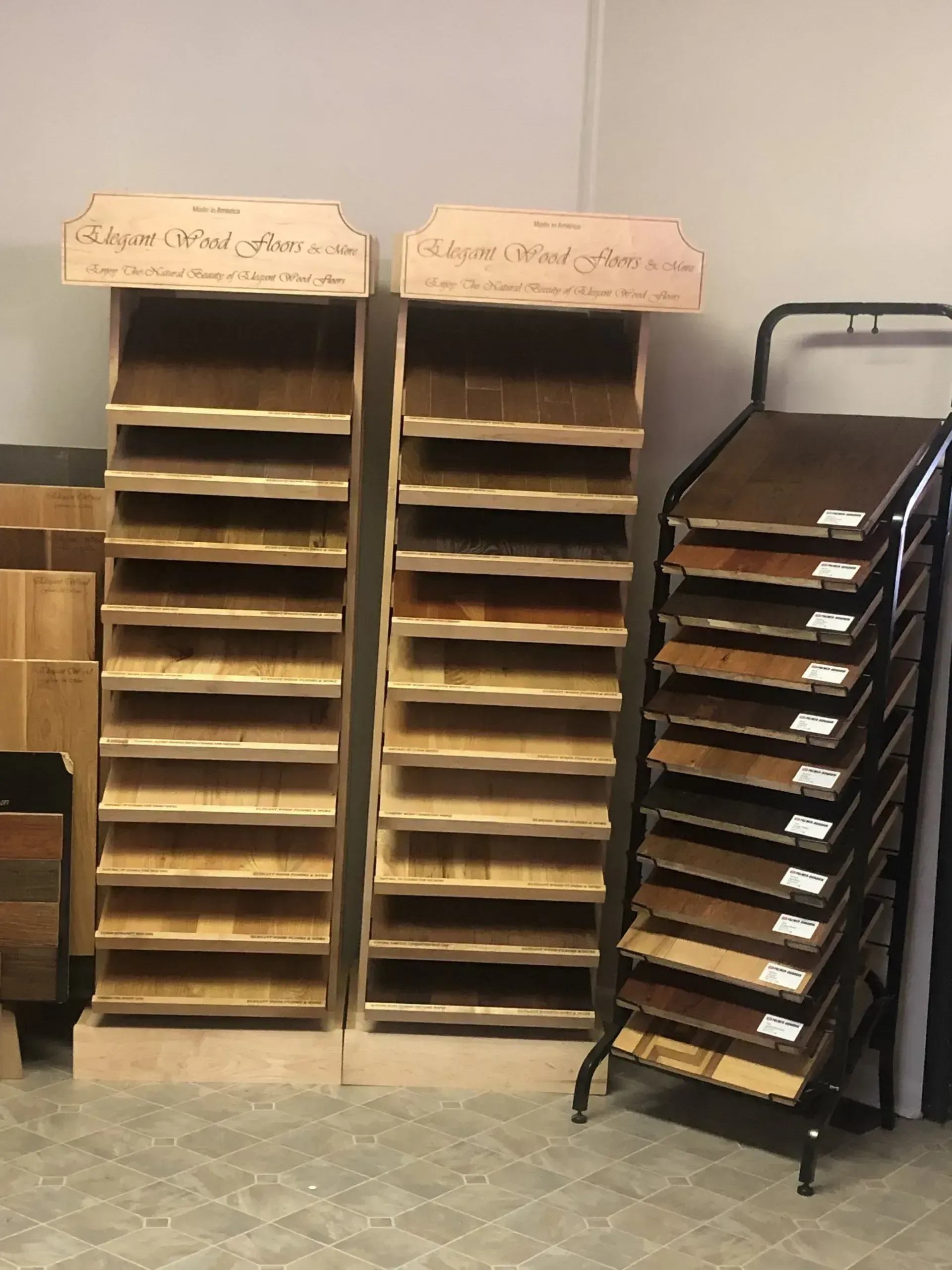 Two wood display stands and a rack showcasing wood flooring samples.