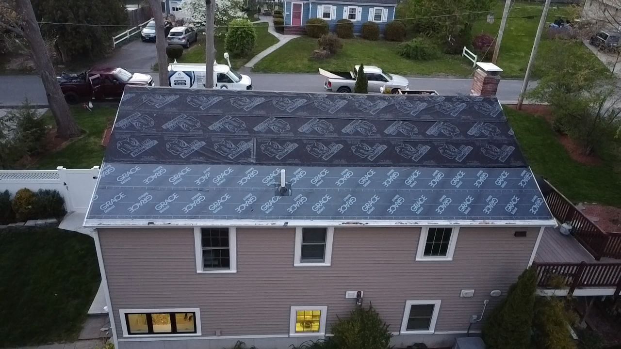 An aerial view of a house with a new roof.