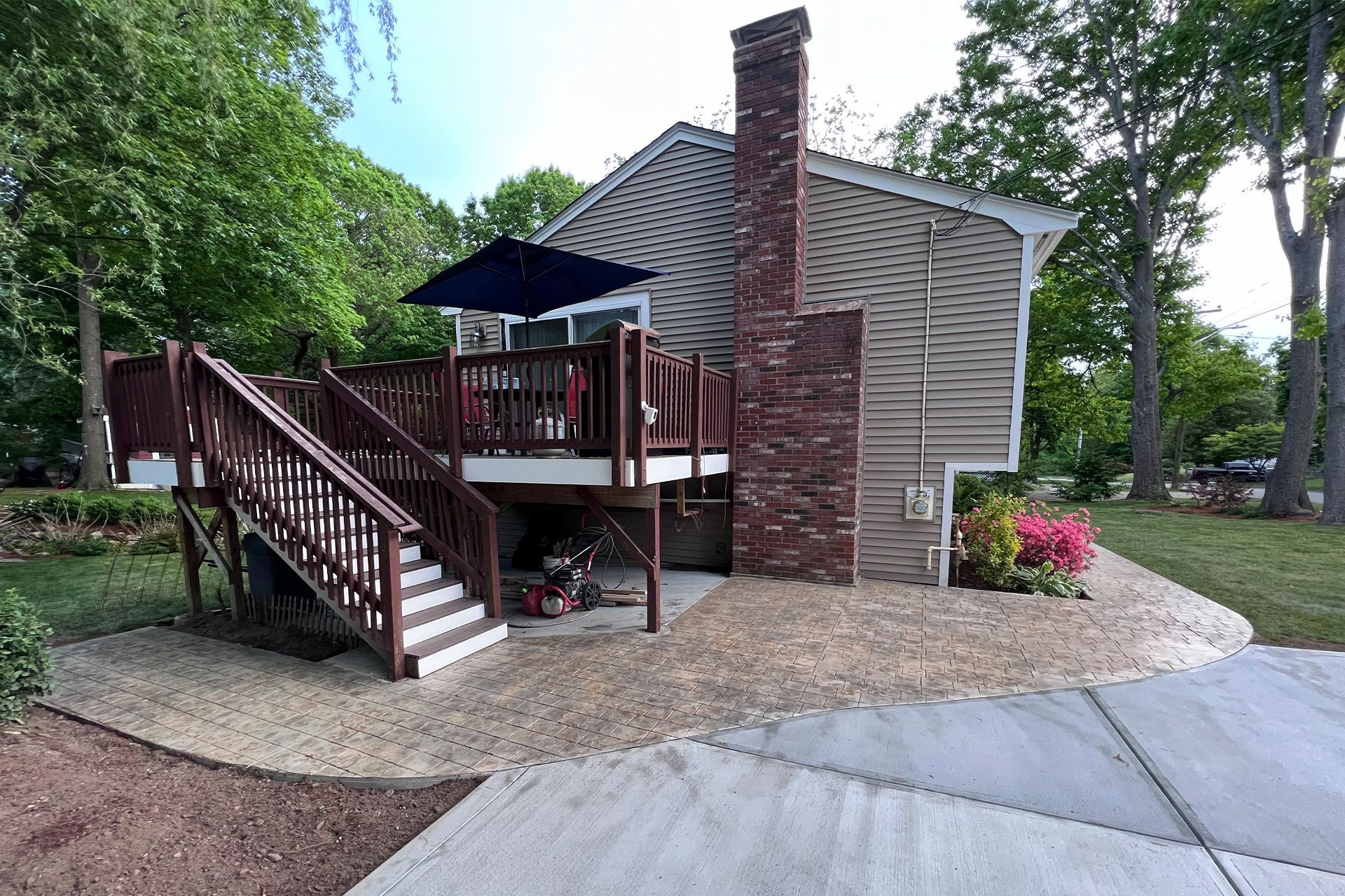 A house with a large deck and stairs leading up to it.