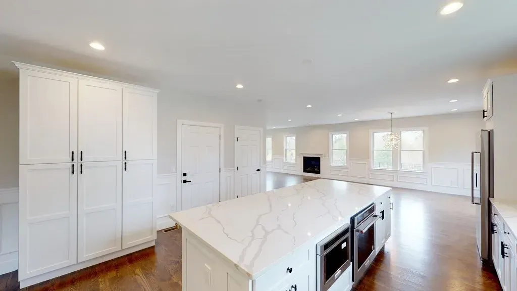 There is a large island in the middle of the kitchen.