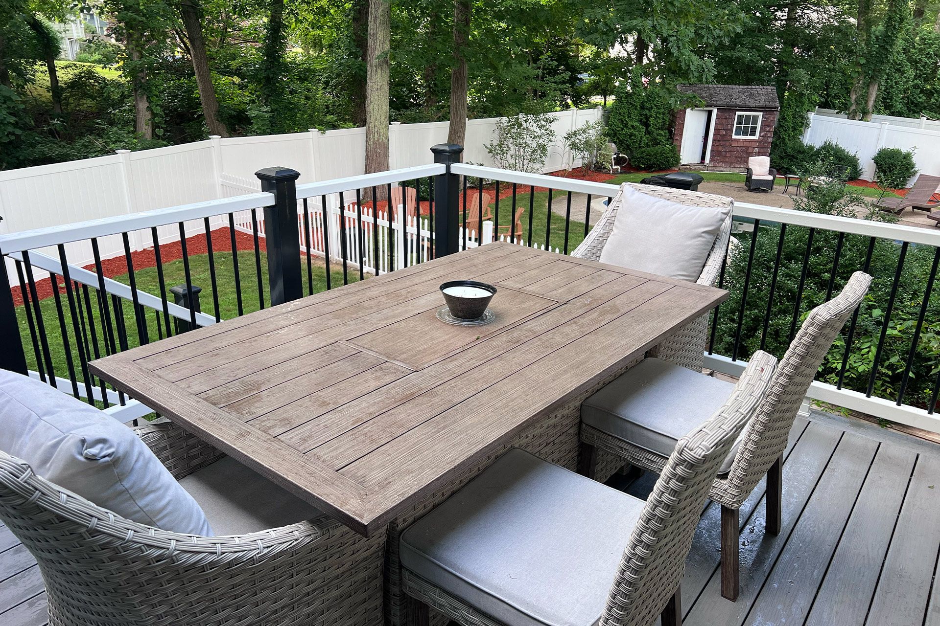 There is a table and chairs on the deck.